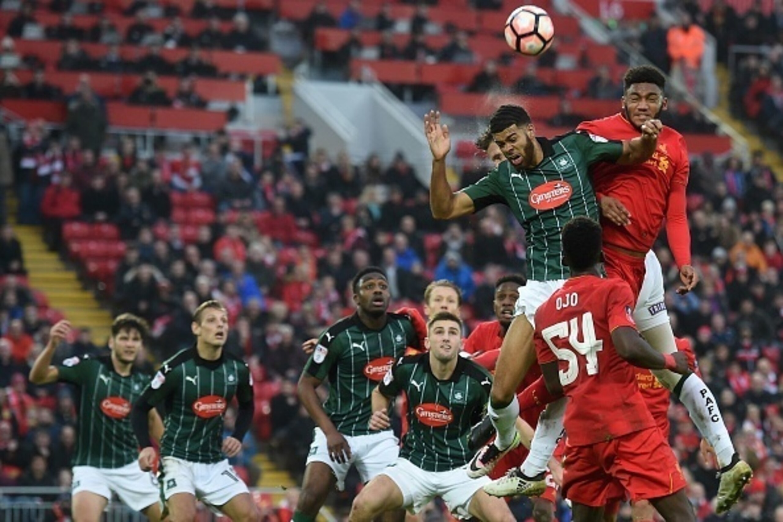 Liverpool's English defender Joe Gomez (R) jumps against Plymouth's English striker Jake Jervis to head the ball during the English FA Cup third round football match between Liverpool and Plymouth Argyle at Anfield in Liverpool, north west England on Janu