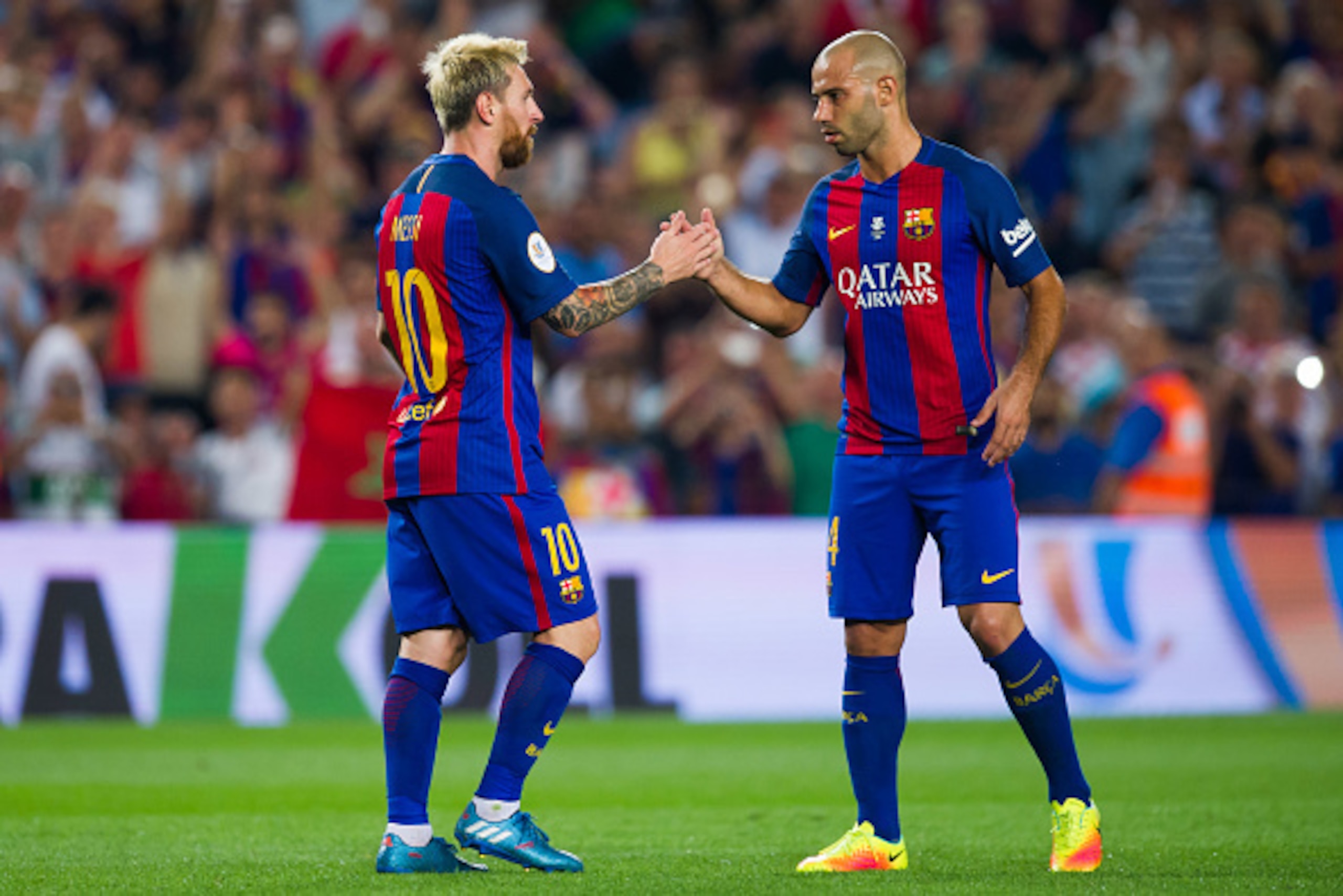 BARCELONA, SPAIN - AUGUST 17: Lionel Messi (L) of FC Barcelona is congratulated by his teammate Javier Mascherano (R) after scoring his team's third goal during the Spanish Super Cup Final second leg match between FC Barcelona and Sevilla FC at Camp Nou o BARCELONA, SPAIN - AUGUST 17: Lionel Messi (L) of FC Barcelona is congratulated by his teammate Javier Mascherano (R) after scoring his team's third goal during the Spanish Super Cup Final second leg match between FC Barcelona and Sevilla FC at Camp Nou o