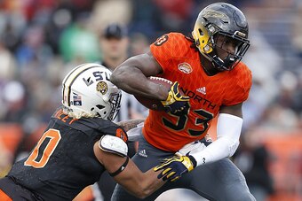 MOBILE, AL - JANUARY 28: Kareem Hunt #33 of the North team runs with the ball as Duke Riley #0 of the South team defends during the second half of the Reese's Senior Bowl at the Ladd-Peebles Stadium on January 28, 2017 in Mobile, Alabama.  (Photo by Jonat