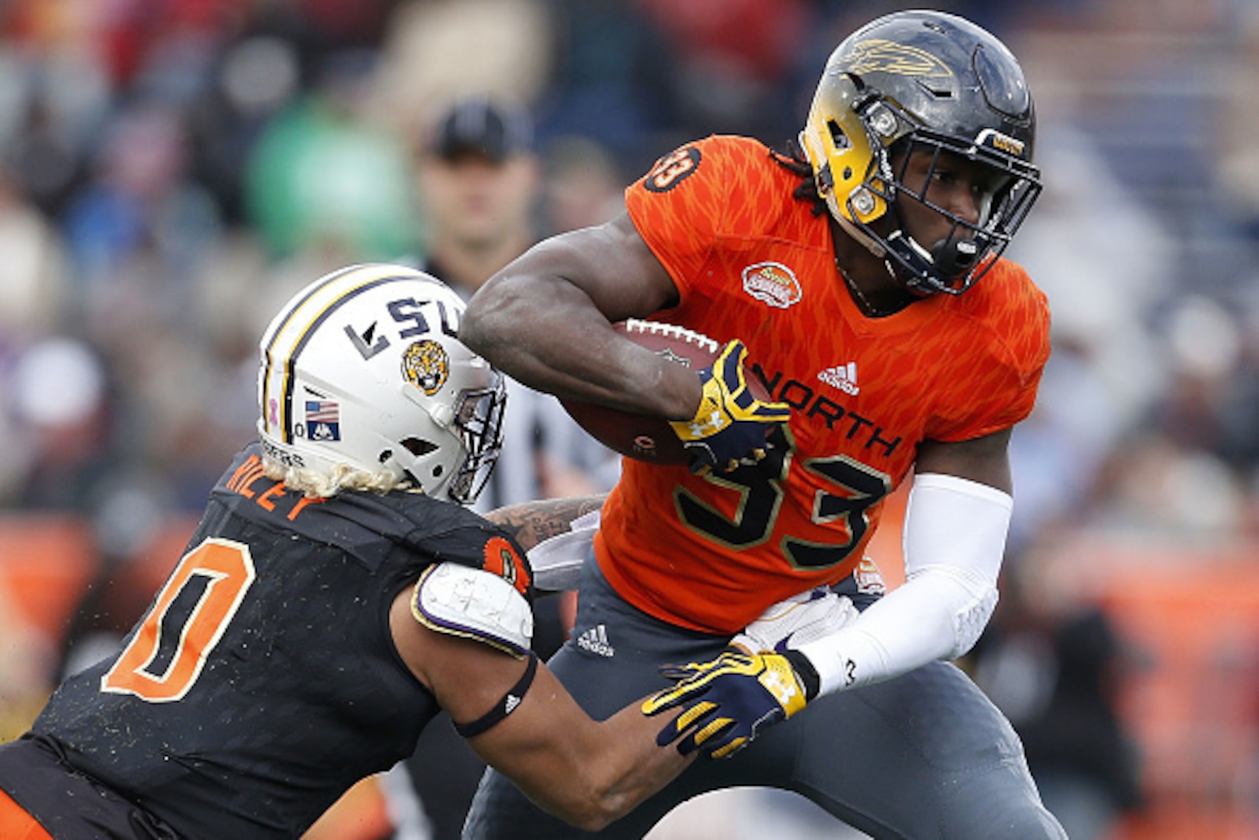 MOBILE, AL - JANUARY 28: Kareem Hunt #33 of the North team runs with the ball as Duke Riley #0 of the South team defends during the second half of the Reese's Senior Bowl at the Ladd-Peebles Stadium on January 28, 2017 in Mobile, Alabama.  (Photo by Jonat