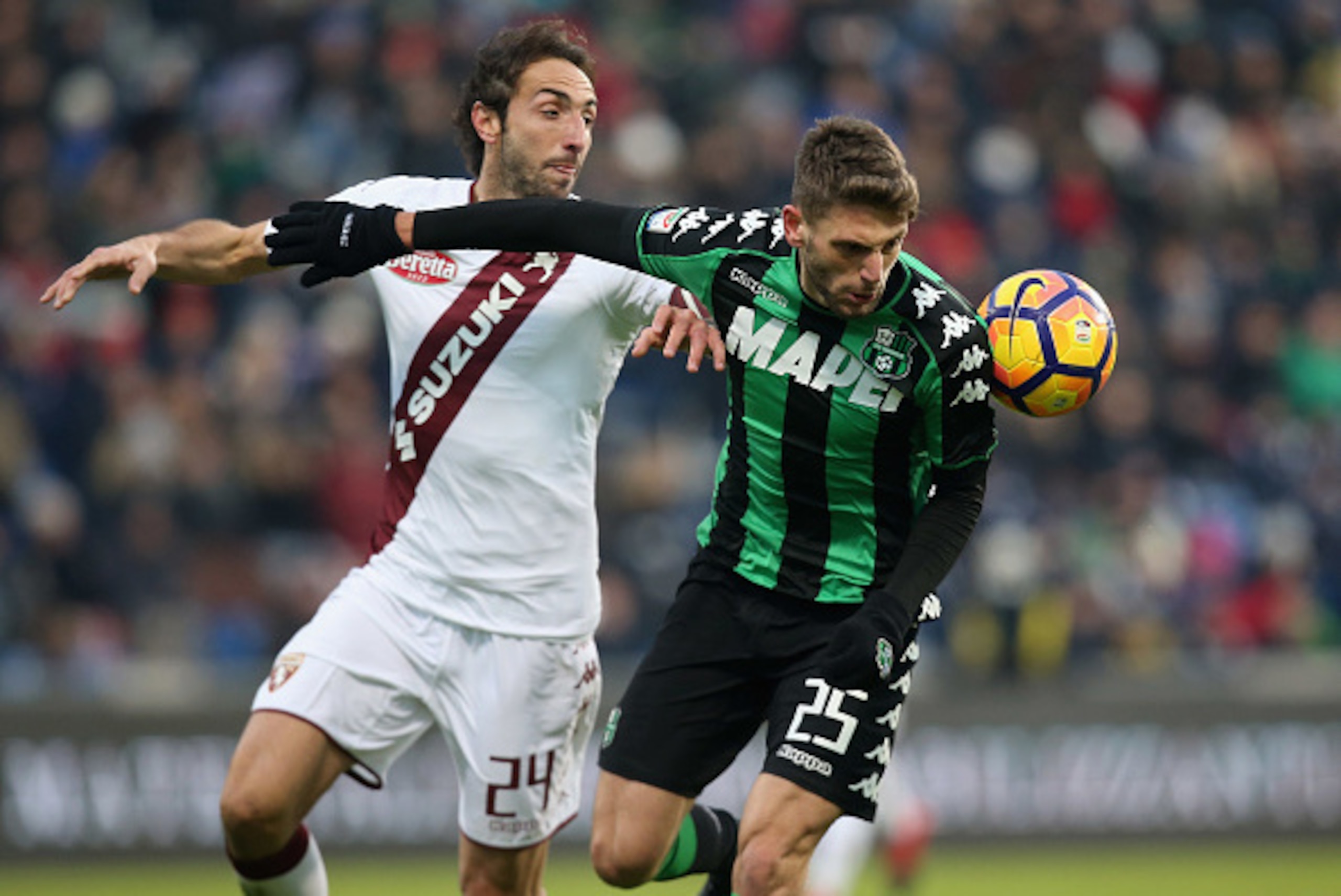 REGGIO NELL'EMILIA, ITALY - JANUARY 08: Domenico Berardi (R) of Sassuolo competes for the ball with Emiliano Moretti of Torino during the Serie A match between US Sassuolo and FC Torino at Mapei Stadium - Citta' del Tricolore on January 8, 2017 in Reggio REGGIO NELL'EMILIA, ITALY - JANUARY 08: Domenico Berardi (R) of Sassuolo competes for the ball with Emiliano Moretti of Torino during the Serie A match between US Sassuolo and FC Torino at Mapei Stadium - Citta' del Tricolore on January 8, 2017 in Reggio