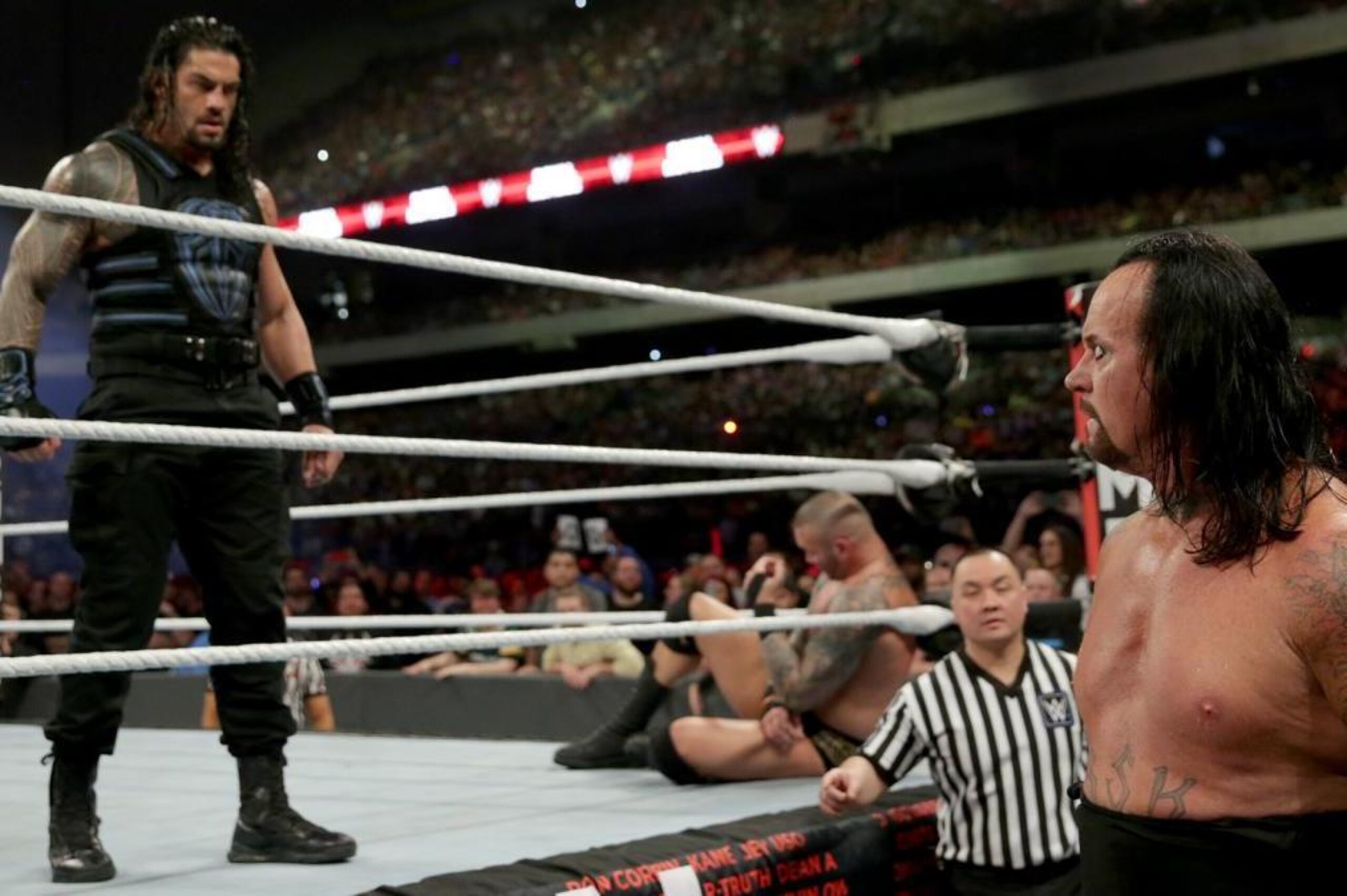 Roman Reigns stares down Undertaker after eliminating him from the Royal Rumble match.