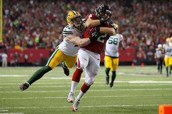 ATLANTA, GA - JANUARY 22:  Patrick DiMarco #42 of the Atlanta Falcons runs with the ball in the first quarter against  Jake Ryan #47 of the Green Bay Packers in the NFC Championship Game at the Georgia Dome on January 22, 2017 in Atlanta, Georgia.  (Photo