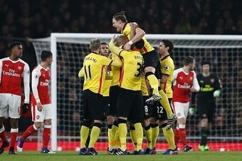 Watford's French midfielder Younes Kaboul (unseen) is mobbed by teammates as he celebrates scoring his team's first goal during the English Premier League football match between Arsenal and Watford at the Emirates Stadium in London on January 31, 2017.
W Watford's French midfielder Younes Kaboul (unseen) is mobbed by teammates as he celebrates scoring his team's first goal during the English Premier League football match between Arsenal and Watford at the Emirates Stadium in London on January 31, 2017.
W