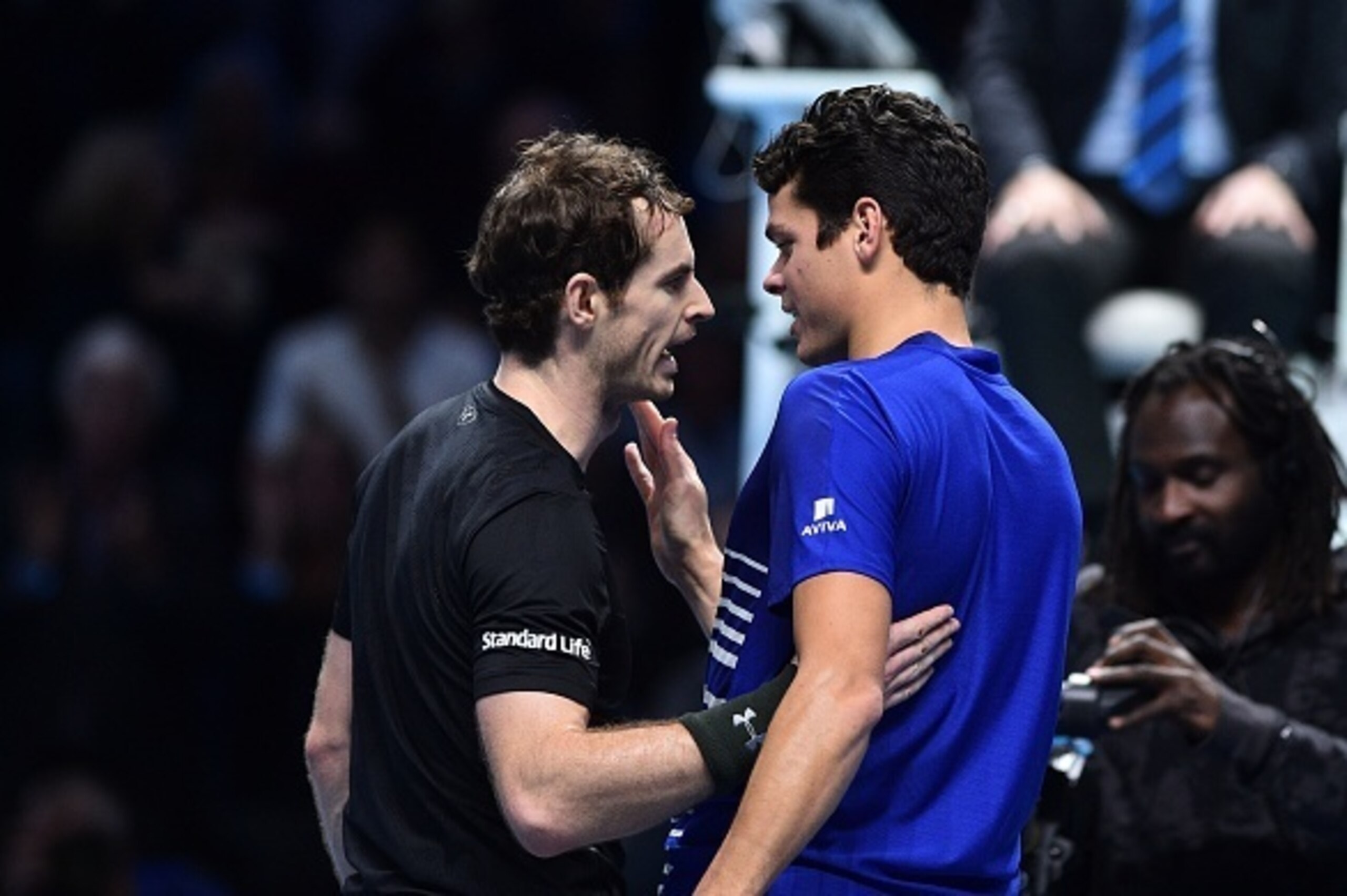 Britain's Andy Murray (L) shakes hands with Canada's Milos Raonic (R) after Murray won their men's semi-final singles match on day seven of the ATP World Tour Finals tennis tournament in London on November 19, 2016. / AFP / Glyn KIRK        (Photo credit 