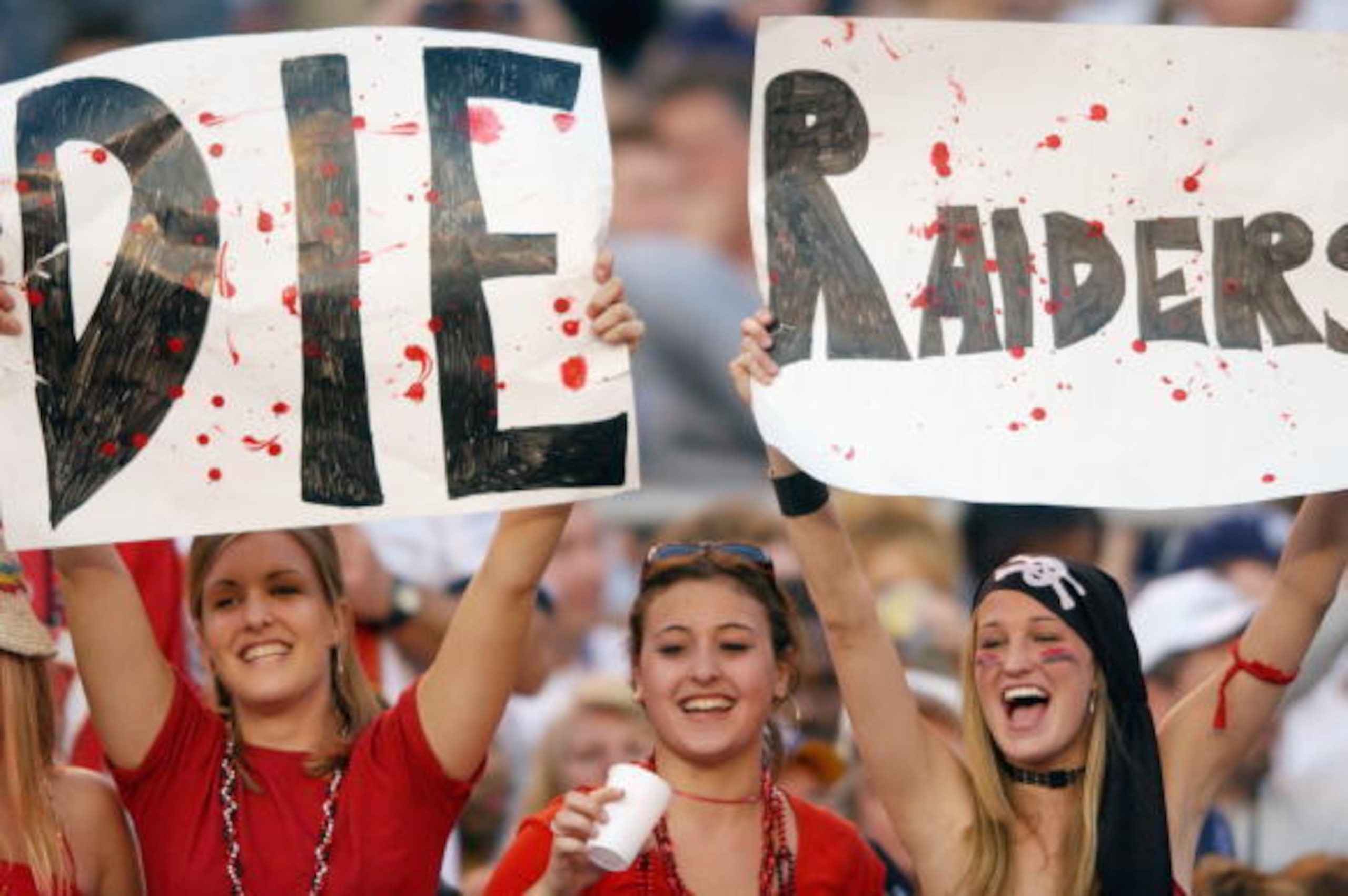 SAN DIEGO - JANUARY 26:  Three female fans of the Tampa Bay Buccaneers show their hate for the Oakland Raiders during Super Bowl XXXVII on January 26, 2003 at Qualcomm Stadium in San Diego, California. The Buccaneers defeated the Raiders 48-21. (Photo by 