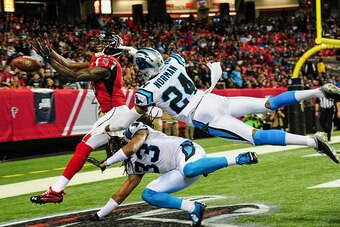 ATLANTA, GA - DECEMBER 28: Josh Norman #24 and Tre Boston #33 of the Carolina Panthers break up a pass intended for Julio Jones #11 of the Atlanta Falcons in the second half at the Georgia Dome on December 28, 2014 in Atlanta, Georgia.  (Photo by Scott Cu