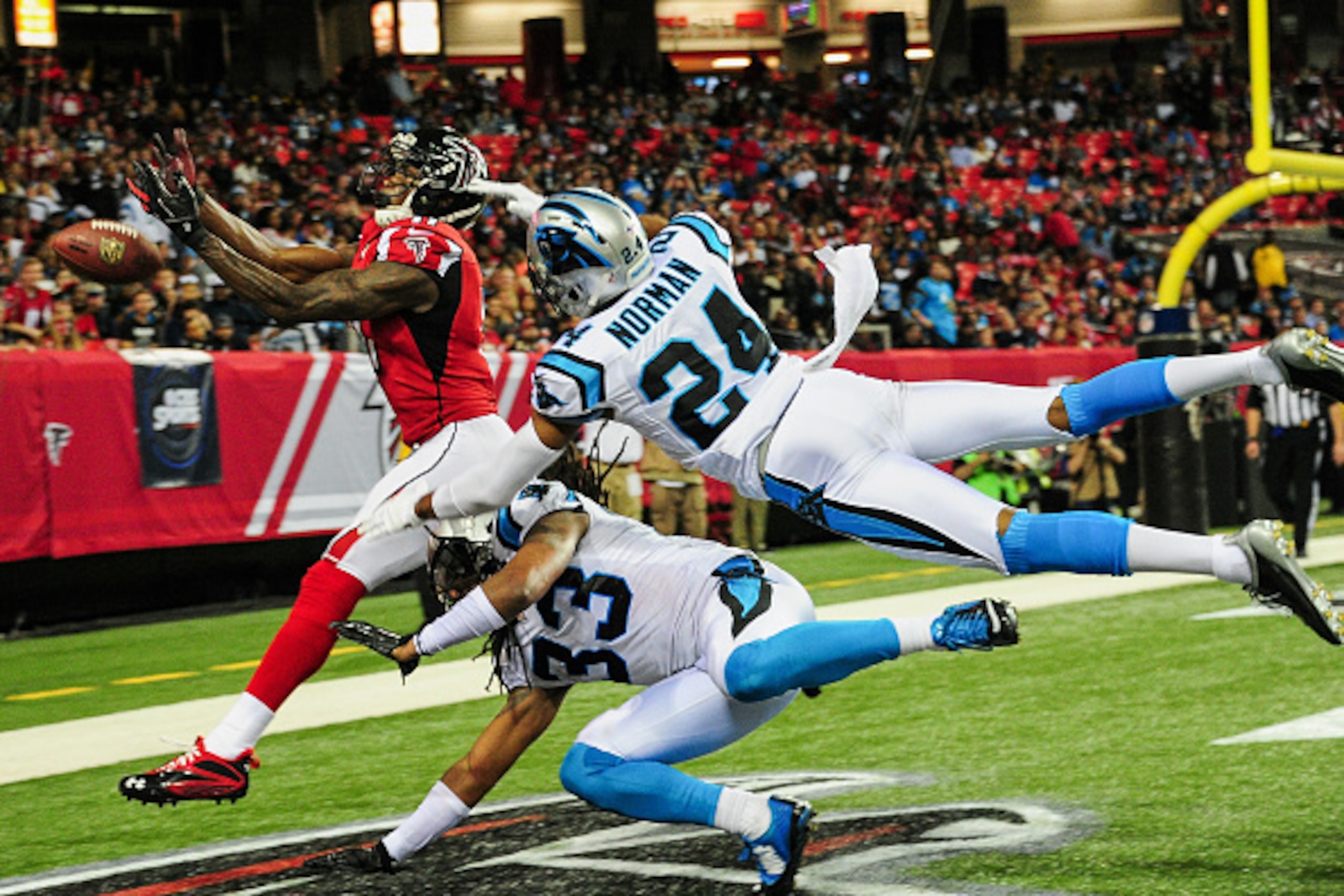 ATLANTA, GA - DECEMBER 28: Josh Norman #24 and Tre Boston #33 of the Carolina Panthers break up a pass intended for Julio Jones #11 of the Atlanta Falcons in the second half at the Georgia Dome on December 28, 2014 in Atlanta, Georgia.  (Photo by Scott Cu