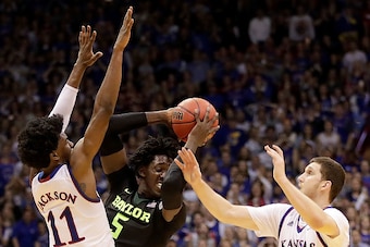 LAWRENCE, KS - FEBRUARY 01:  Johnathan Motley #5 of the Baylor Bears looks to pass as Josh Jackson #11 and Sviatoslav Mykhailiuk #10 of the Kansas Jayhawks defend during the game at Allen Fieldhouse on February 1, 2017 in Lawrence, Kansas.  (Photo by Jami
