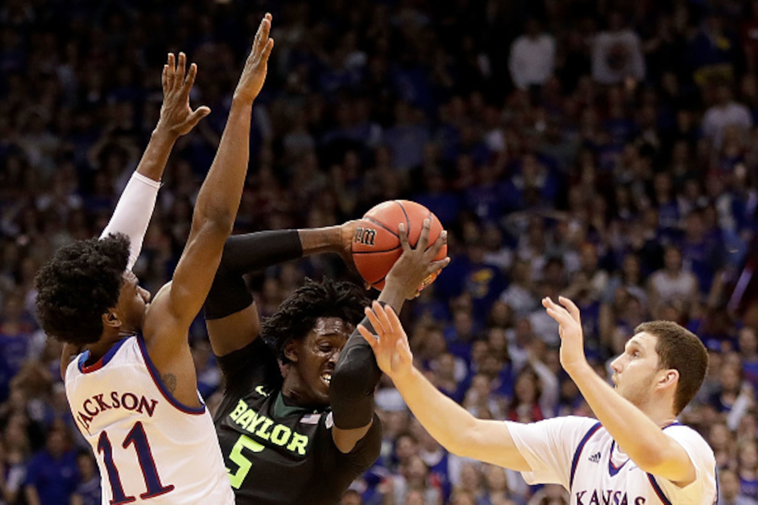 LAWRENCE, KS - FEBRUARY 01:  Johnathan Motley #5 of the Baylor Bears looks to pass as Josh Jackson #11 and Sviatoslav Mykhailiuk #10 of the Kansas Jayhawks defend during the game at Allen Fieldhouse on February 1, 2017 in Lawrence, Kansas.  (Photo by Jami