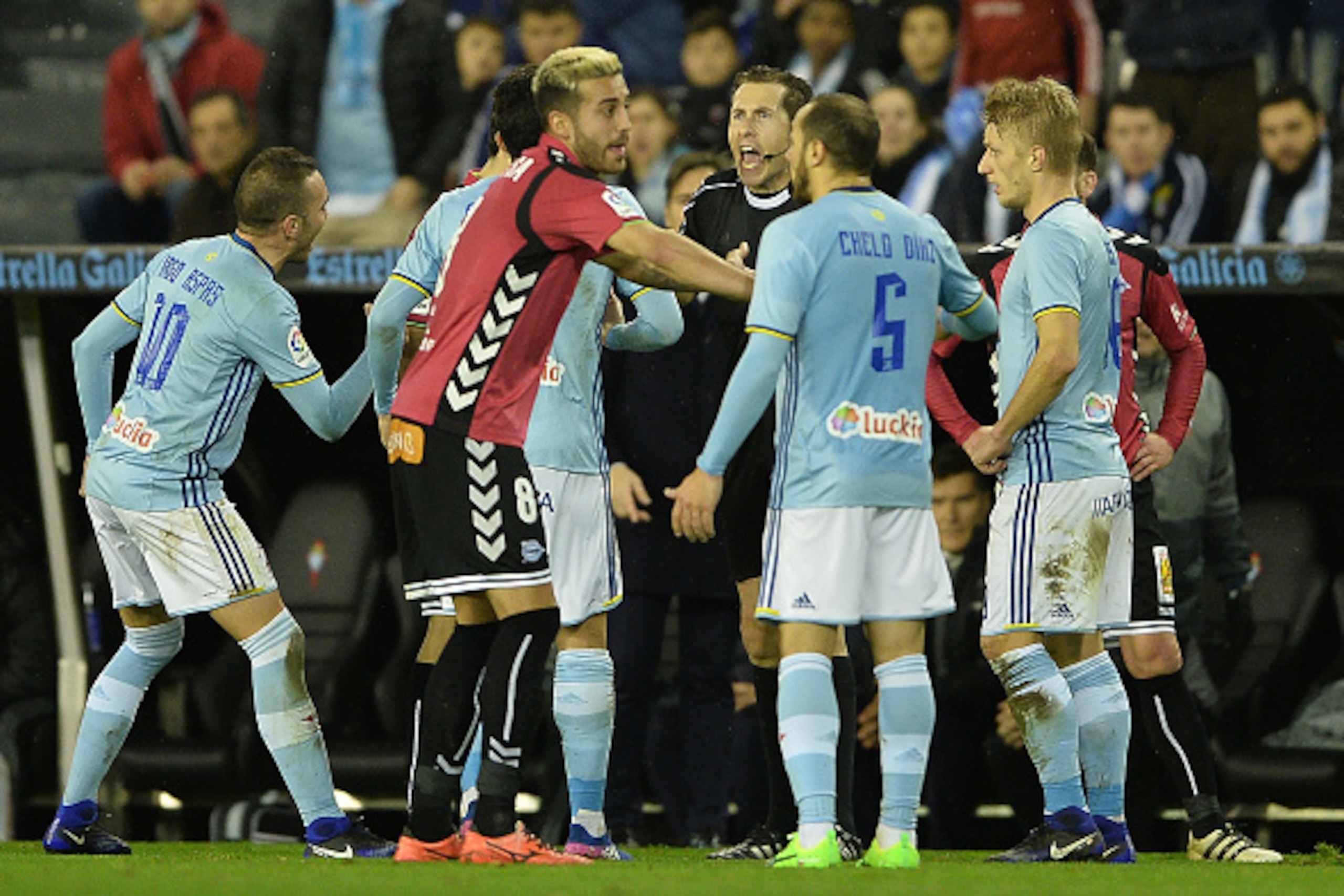 VIGO, SPAIN - FEBRUARY 02: Gonzalez Gonzalez the referee argues with the player of Celta de Vigo and Alaves during the Copa del Rey semi-final first leg match between Real Club Celta de Vigo and Deportivo Alaves at Municipal de Balaidos stadium on Februar