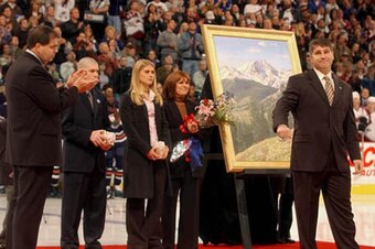 Lacroix, left, saluting former Av Ray Bourque at a ceremony in Denver.