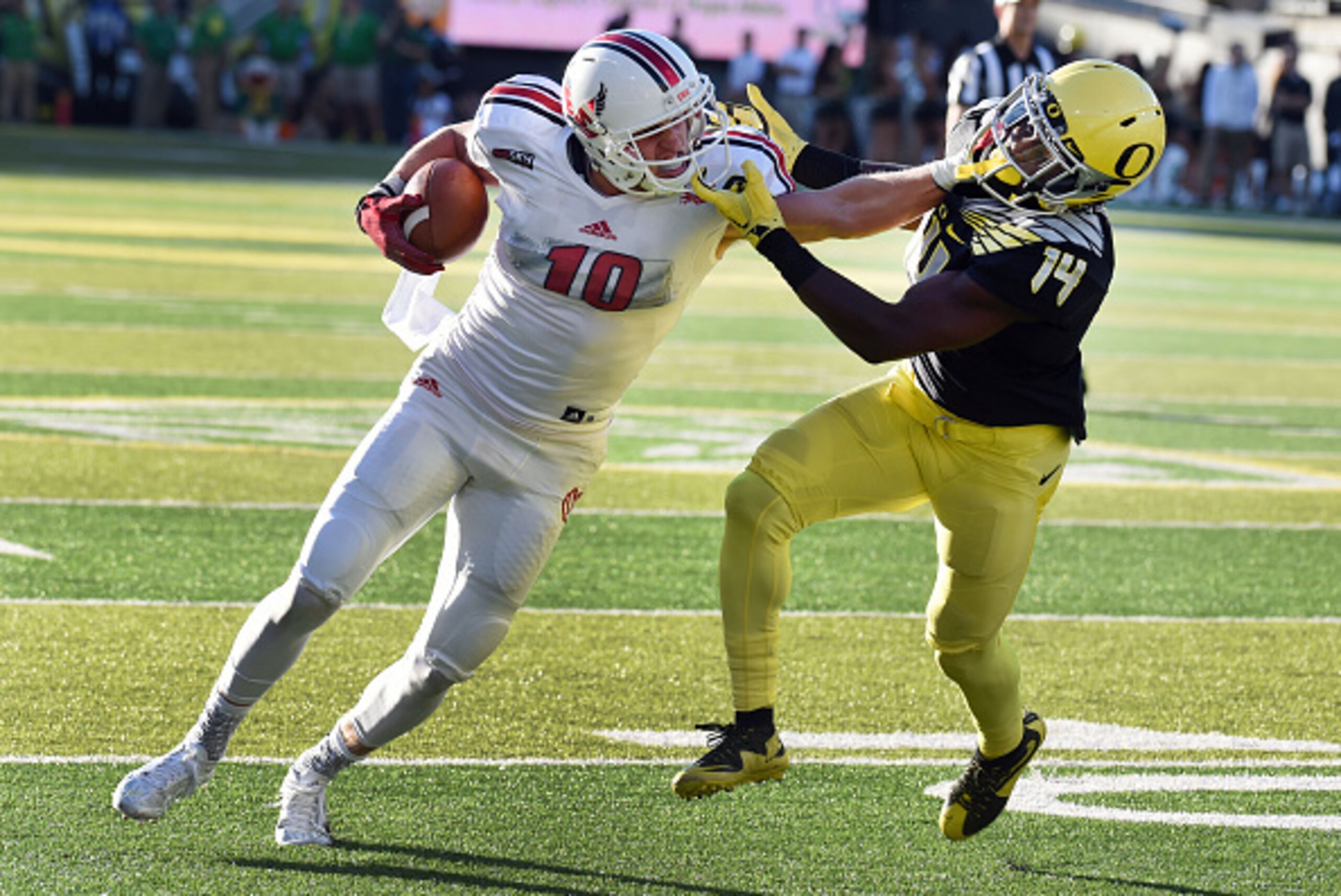 EUGENE, OR - SEPTEMBER 05: Wide receiver Cooper Kupp #10 of the Eastern Washington Eagles stiff arms cornerback Ugo Amadi #14 of the Oregon Ducks on the way to  touchdown during the second quarter of the game against the Oregon Ducks at Autzen Stadium on 