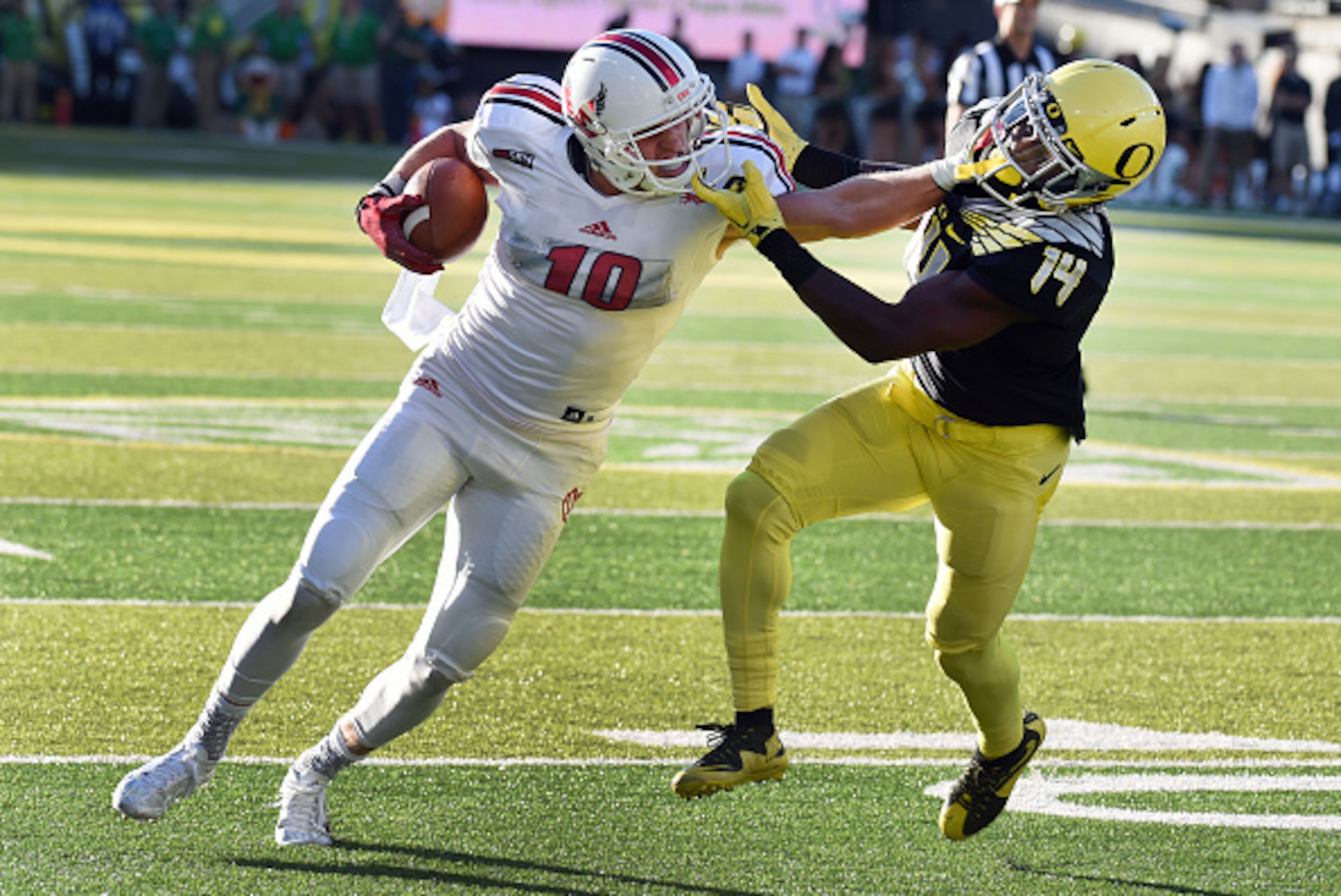 EUGENE, OR - SEPTEMBER 05: Wide receiver Cooper Kupp #10 of the Eastern Washington Eagles stiff arms cornerback Ugo Amadi #14 of the Oregon Ducks on the way to  touchdown during the second quarter of the game against the Oregon Ducks at Autzen Stadium on 