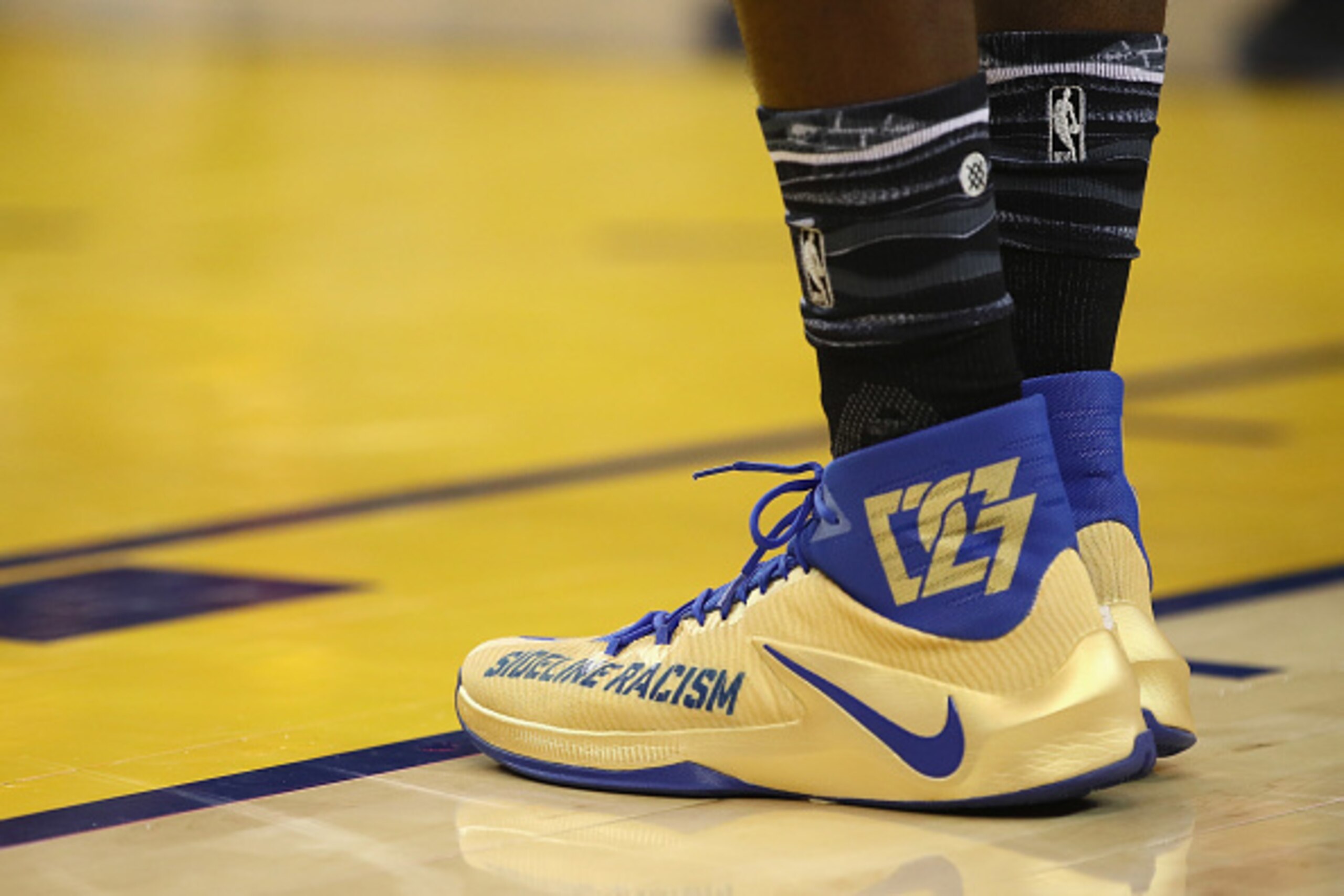 OAKLAND, CA - JANUARY 16:  Draymond Green #23 of the Golden State Warriors wears Nike shoes that say 'Sideline Racism' during their game against the Cleveland Cavaliers at ORACLE Arena on January 16, 2017 in Oakland, California. NOTE TO USER: User express