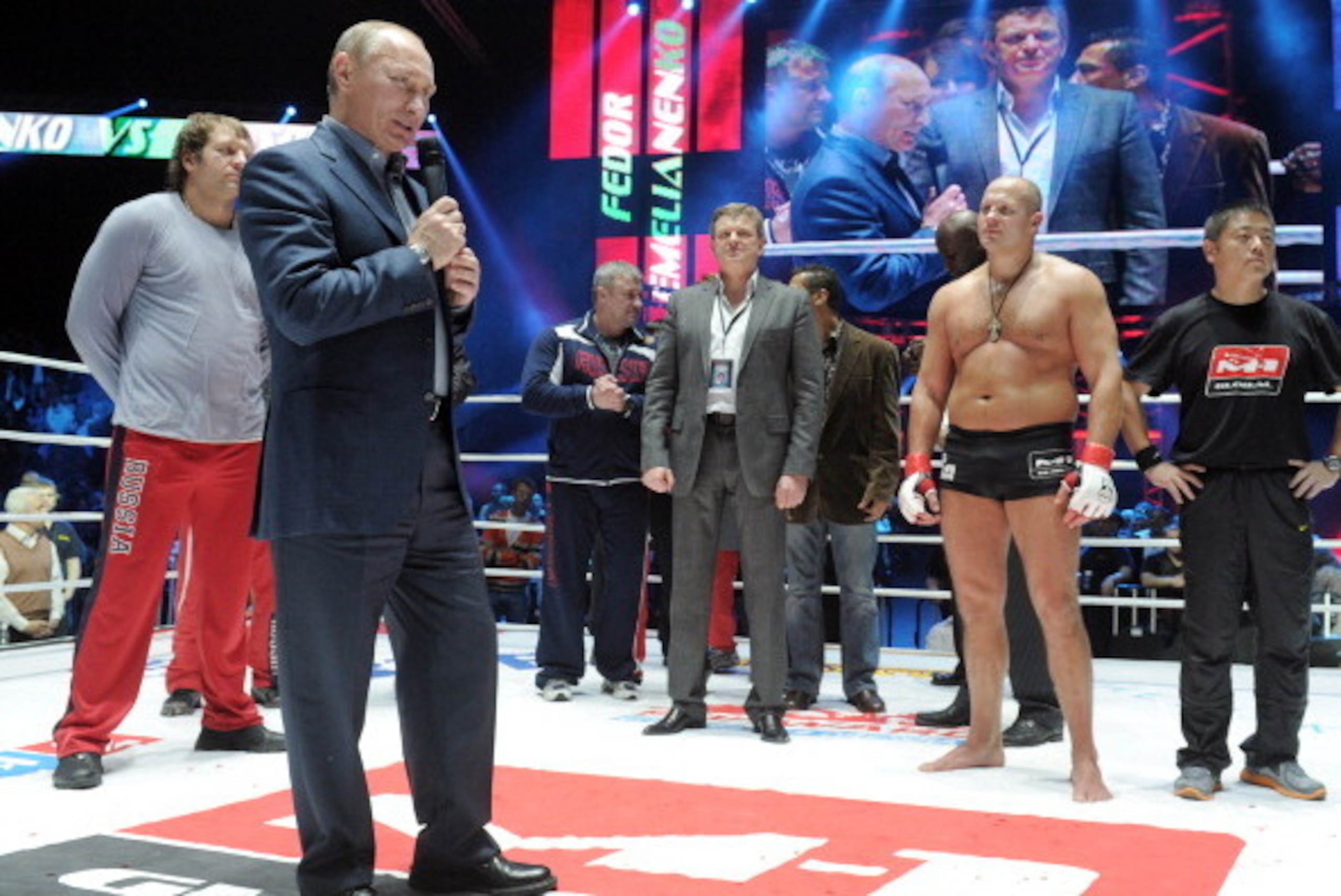 Russia's Prime Minister Vladimir Putin (L) congratulates Mixed Martial Art (MMA) Russian heavyweight fighter Fedor Emelianenko (2R) after his victory over Jeff Monson of the US in Moscow, on November 20, 2011. AFP PHOTO/ RIA NOVOSTI/ POOL/ALEXEY DRUZHININ