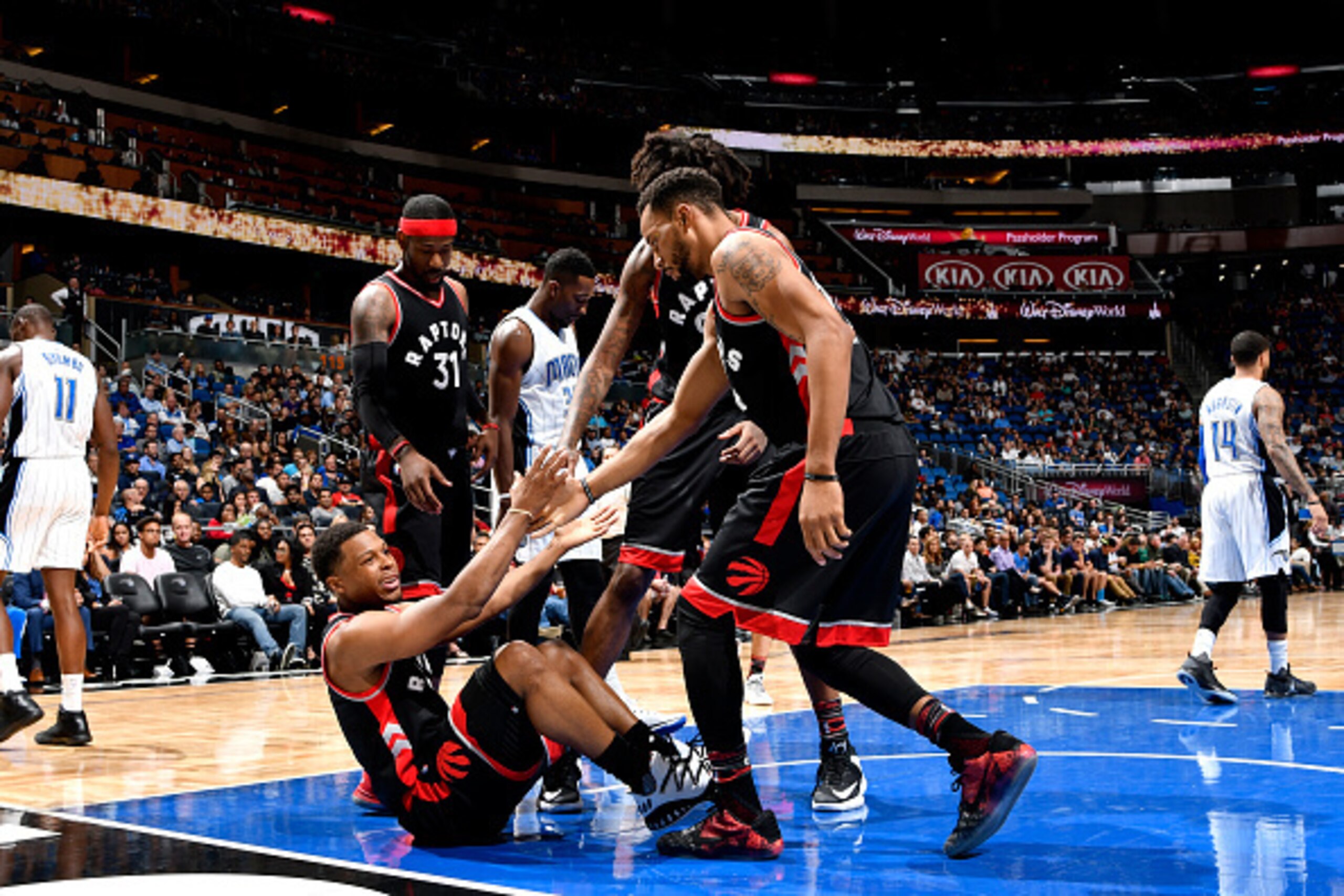 ORLANDO, FL - FEBRUARY 3: Norman Powell #24 and Lucas Nogueira #92 help up their teammate Kyle Lowry #7 of the Toronto Raptors during the game against the Orlando Magic on February 3, 2017 at Amway Center in Orlando, Florida. NOTE TO USER: User expressly 