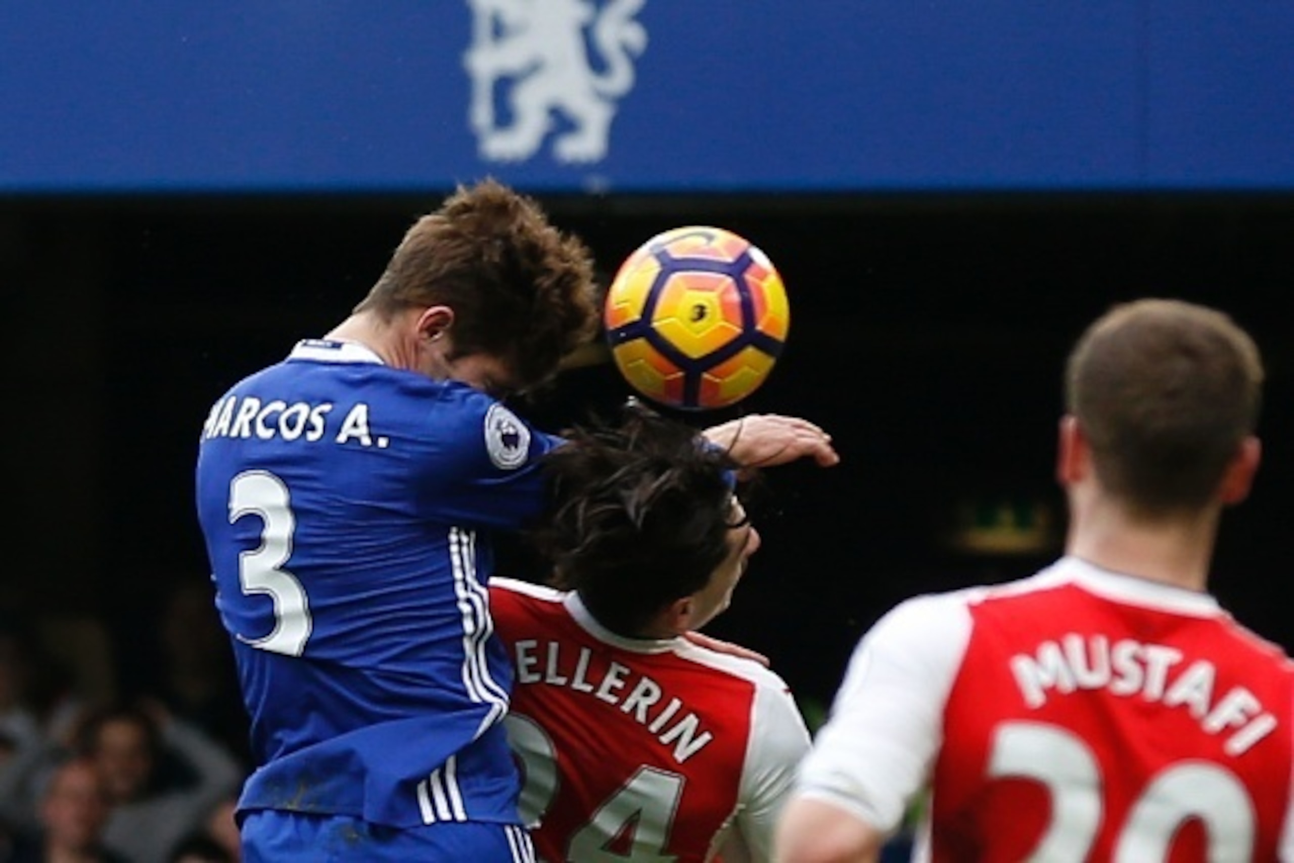 Chelsea's Spanish defender Marcos Alonso (L) rises above Arsenal's Spanish defender Hector Bellerin (C) to score the opening goal during the English Premier League football match between Chelsea and Arsenal at Stamford Bridge in London on February 4, 2017