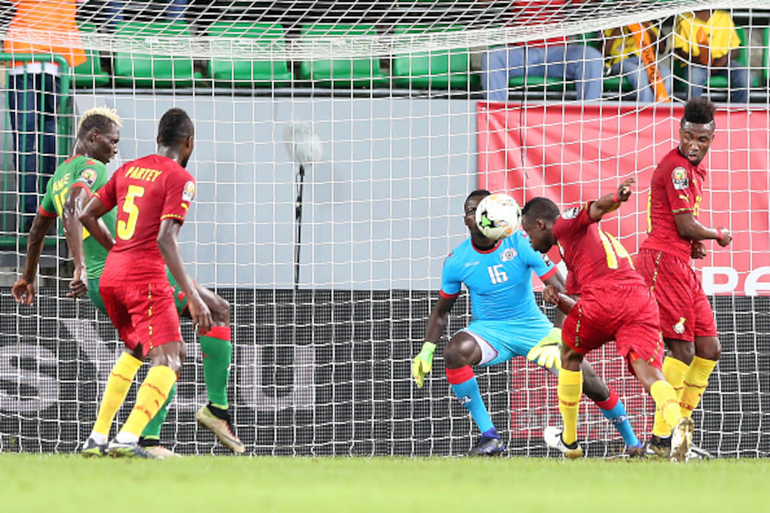 Burkina Faso's goalkeeper Herve Kouakou Koffi (back) prepares to block a header by Ghana's forward Bernard Tekpetey (2nd-R) during the 2017 Africa Cup of Nations third place football match between Burkina Faso and Ghana in Port-Gentil on February 4, 2017.
