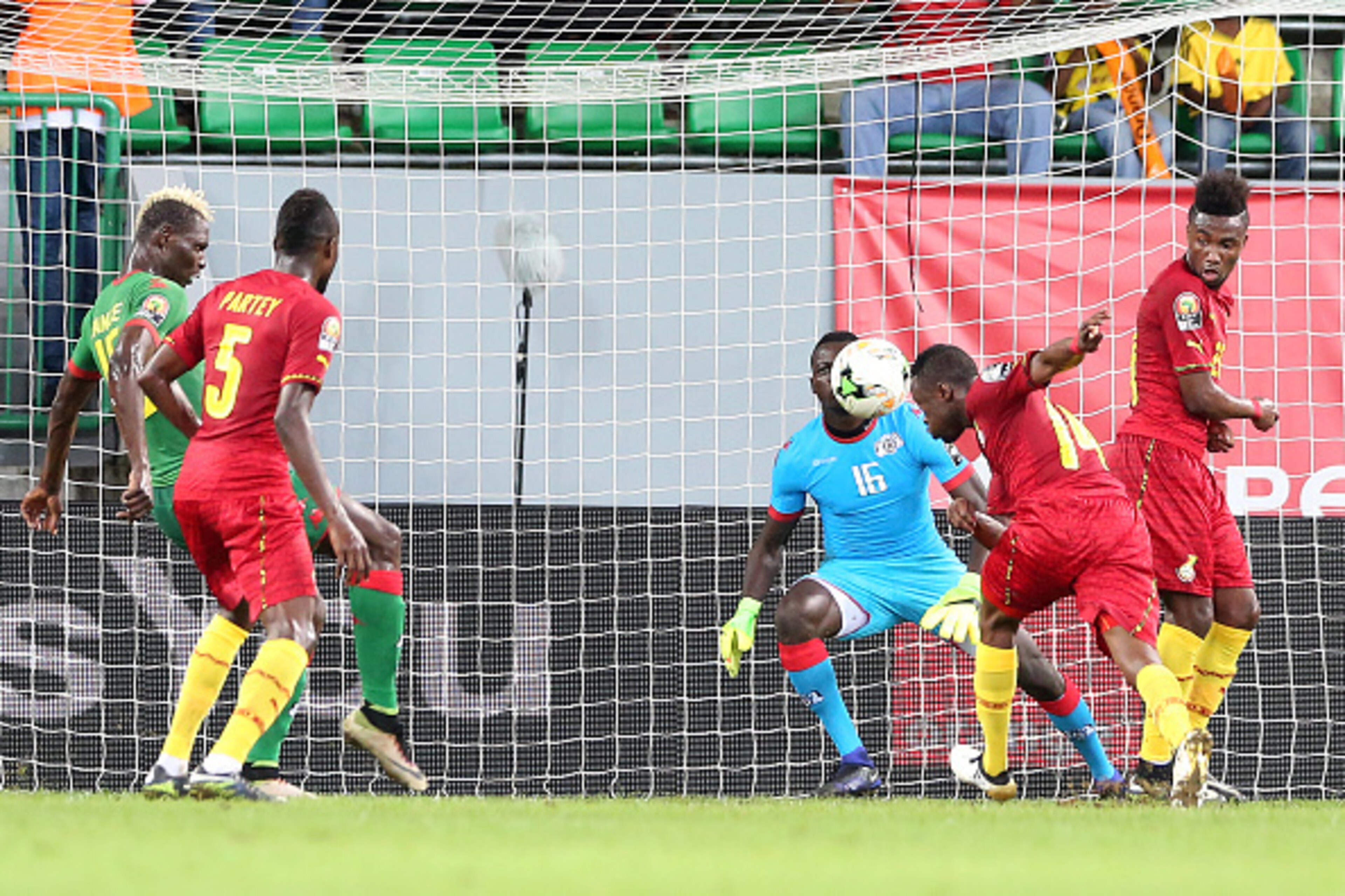 Burkina Faso's goalkeeper Herve Kouakou Koffi (back) prepares to block a header by Ghana's forward Bernard Tekpetey (2nd-R) during the 2017 Africa Cup of Nations third place football match between Burkina Faso and Ghana in Port-Gentil on February 4, 2017.