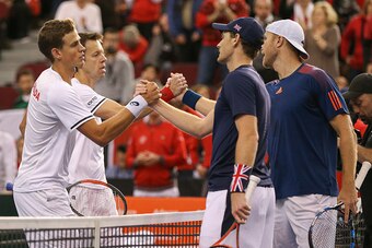 OTTAWA, ON - FEBRUARY 4: Dominic Inglot and Jamie Murray of Great Britain shake hands with Vasek Pospisil and Daniel Nestor of Canada after their win in the doubles match on day two of the Davis Cup World Group match between Great Britain and Canada at TD