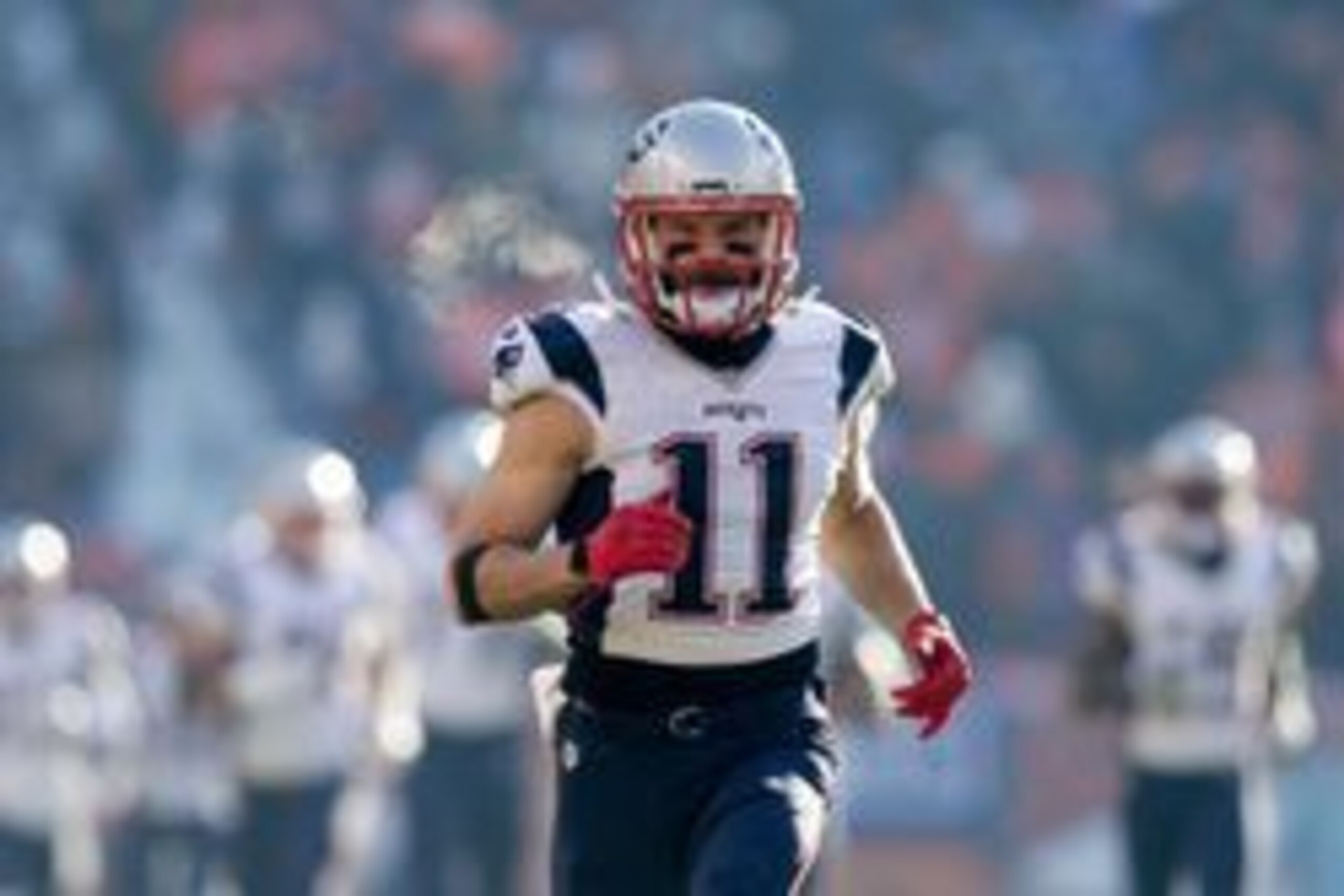 Dec 18, 2016; Denver, CO, USA; New England Patriots wide receiver Julian Edelman (11) runs onto the field before the game against the Denver Broncos at Sports Authority Field at Mile High. Mandatory Credit: Isaiah J. Downing-USA TODAY Sports