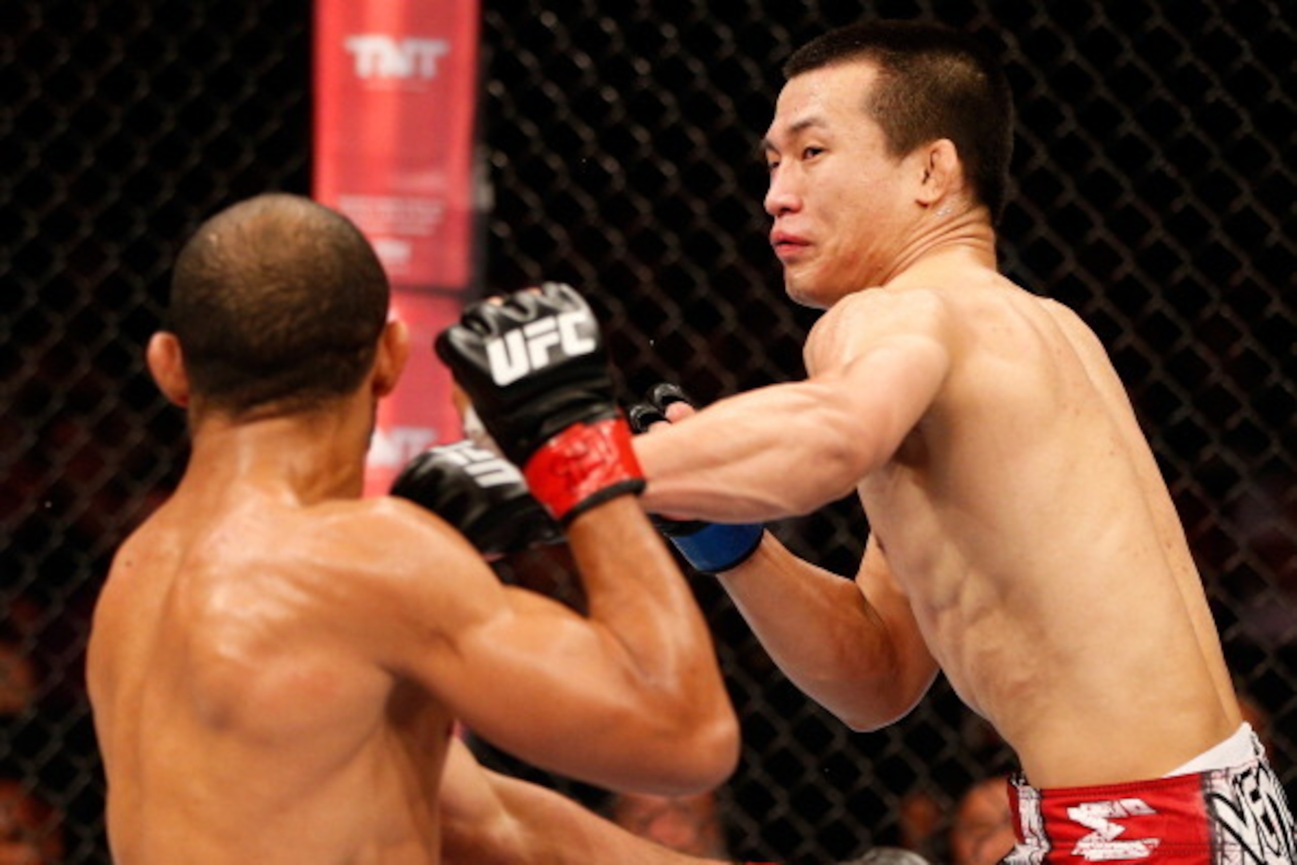 RIO DE JANEIRO, BRAZIL - AUGUST 03:  (R-L) 'The Korean Zombie' Chan Sung Jung punches Jose Aldo in their featherweight championship bout during UFC 163 at HSBC Arena on August 3, 2013 in Rio de Janeiro, Brazil. (Photo by Josh Hedges/Zuffa LLC/Zuffa LLC vi