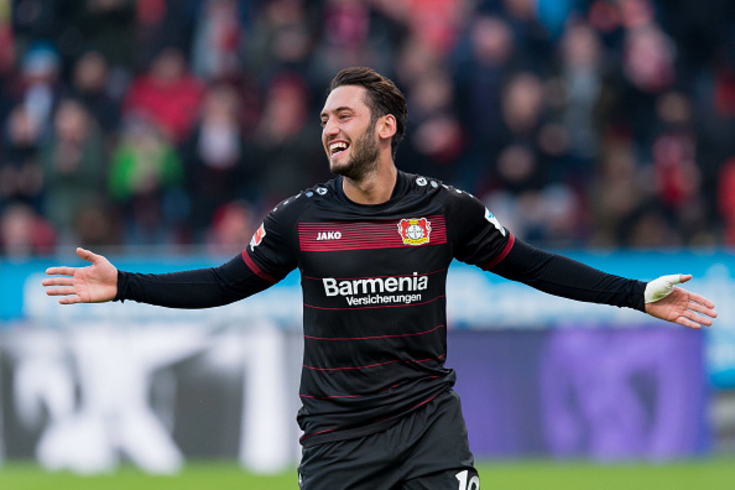 LEVERKUSEN, GERMANY - JANUARY 22: Hakan Calhanoglu of Leverkusen celebrates his goal during the Bundesliga match between Bayer 04 Leverkusen and Hertha BSC at BayArena on January 22, 2017 in Leverkusen, Germany. (Photo by TF-Images/Getty Images)
