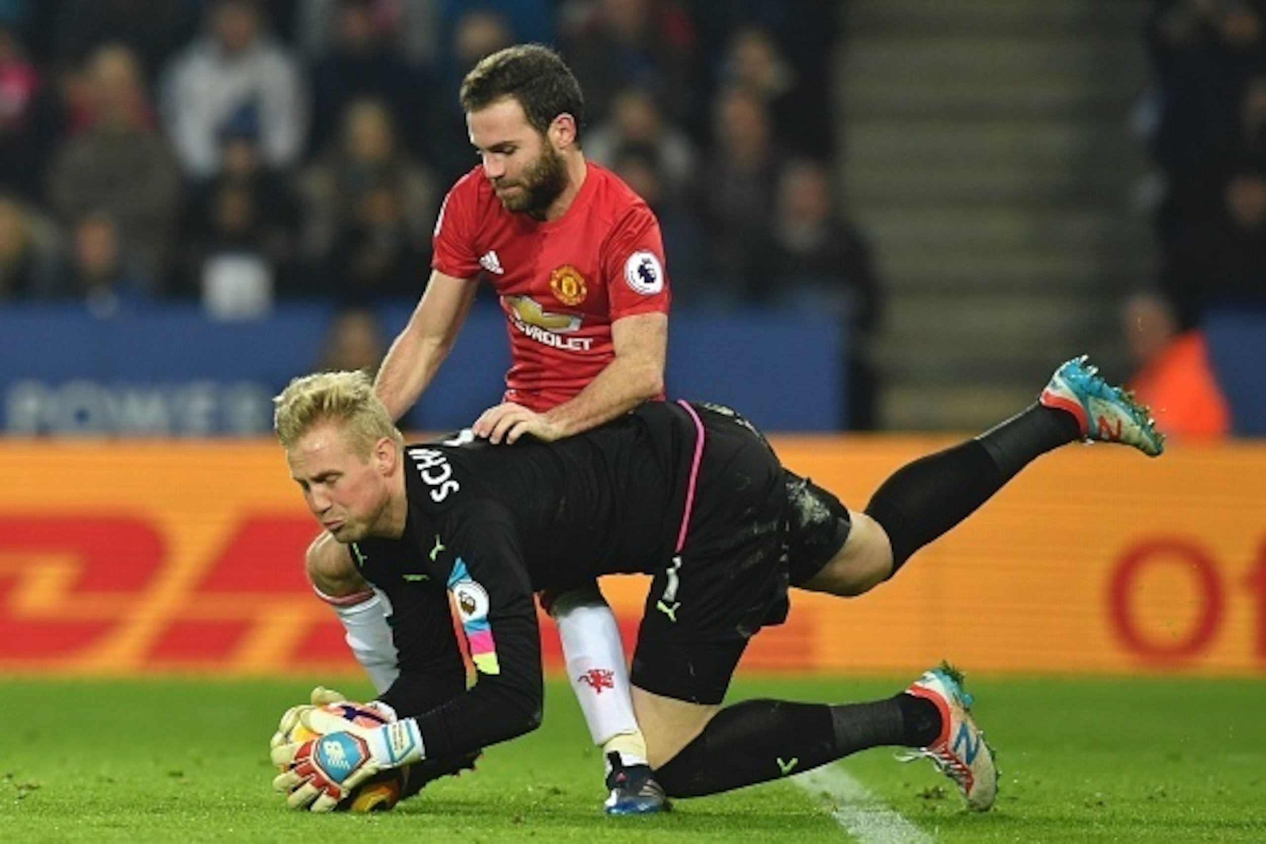Leicester City's Danish goalkeeper Kasper Schmeichel makes a save to prevent Manchester United's Spanish midfielder Juan Mata having a shot on goal during the English Premier League football match between Leicester City and Manchester United at King Power