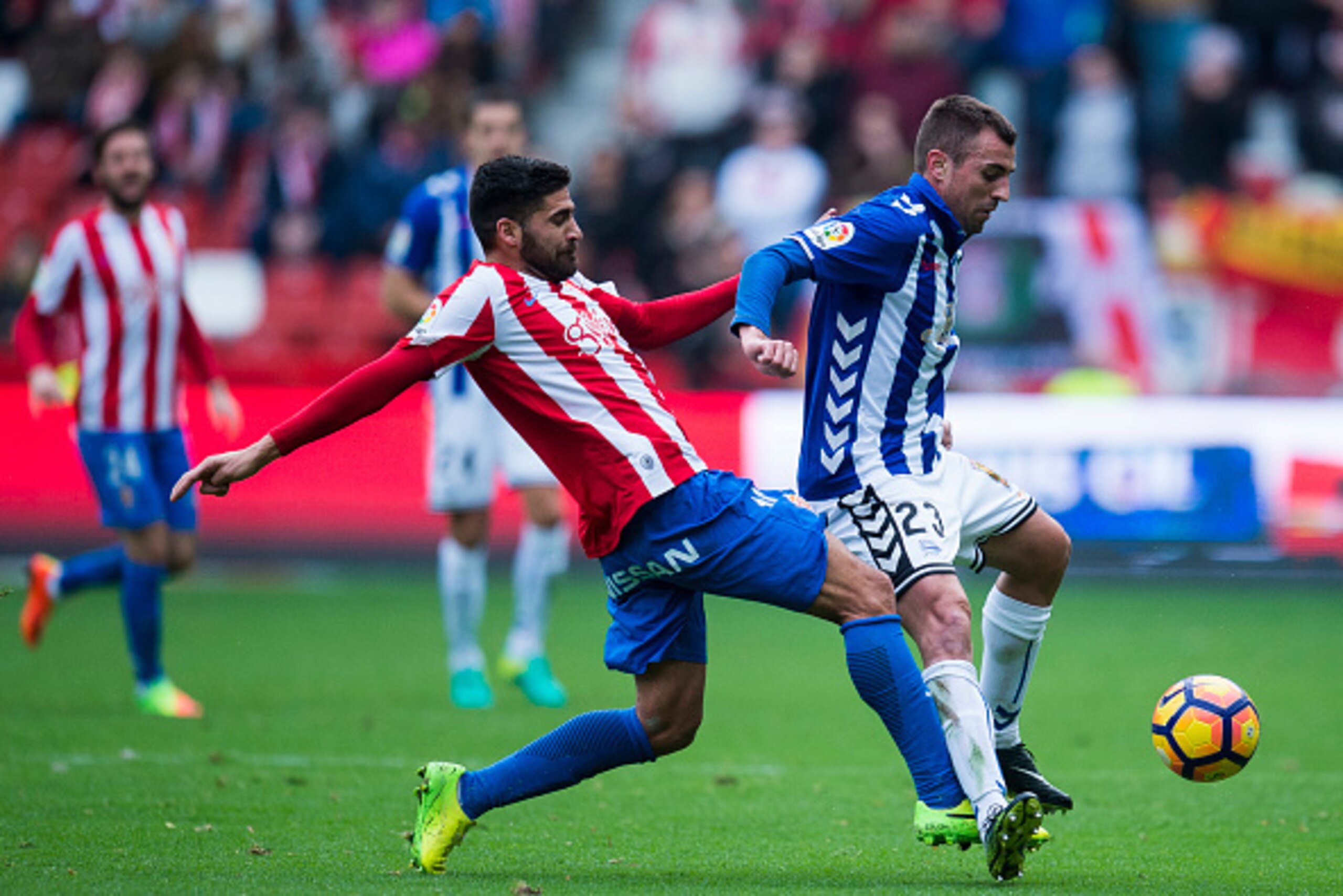 GIJON, SPAIN - FEBRUARY 05: Nenad Krsticic of Deportivo Alaves duels for the ball with Carlos Carmona of Real Sporting de Gijon during the La Liga match between Real Sporting de Gijon and Deportivo Alaves at Estadio El Molinon on February 5, 2017 in Gijon