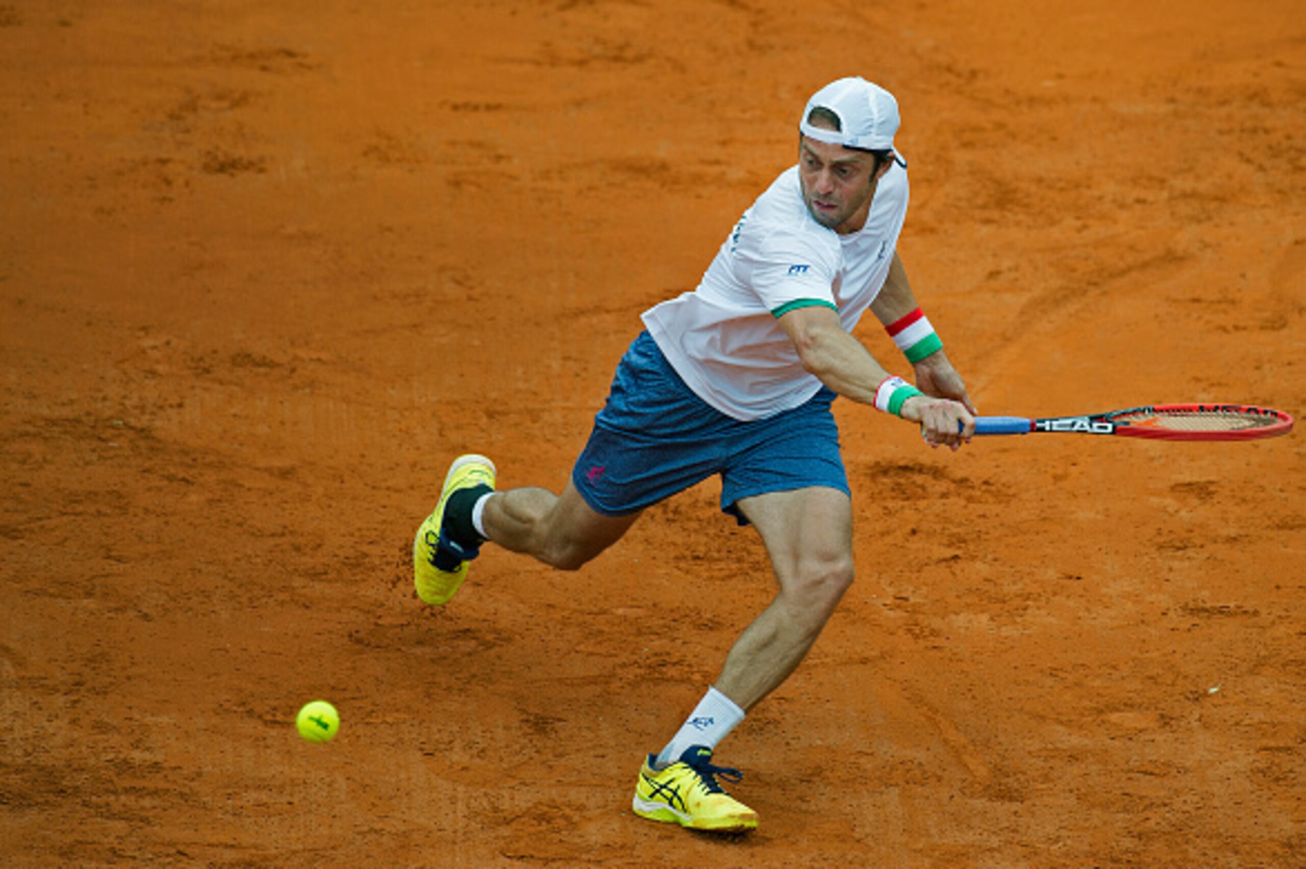 Italy's tennis player Paolo Lorenzi hits a return against Argentina's tennis player Carlos Berlocq (out of frame) during the 2017 Davis Cup World Group first round single tennis match at Parque Sarmiento stadium in Buenos Aires on February 5, 2017.  / AFP