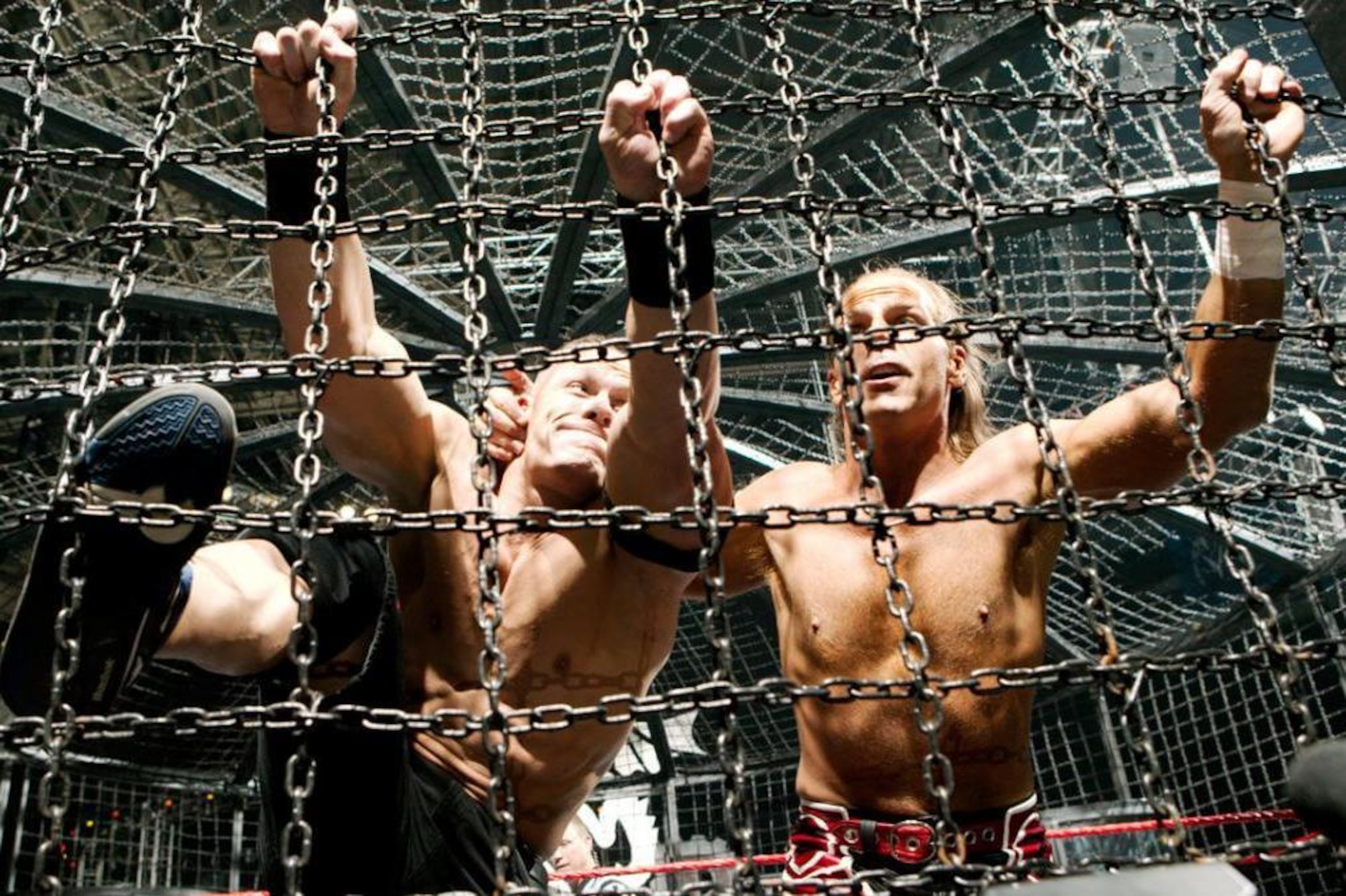 John Cena and Shawn Michaels battle inside the Elimination Chamber.