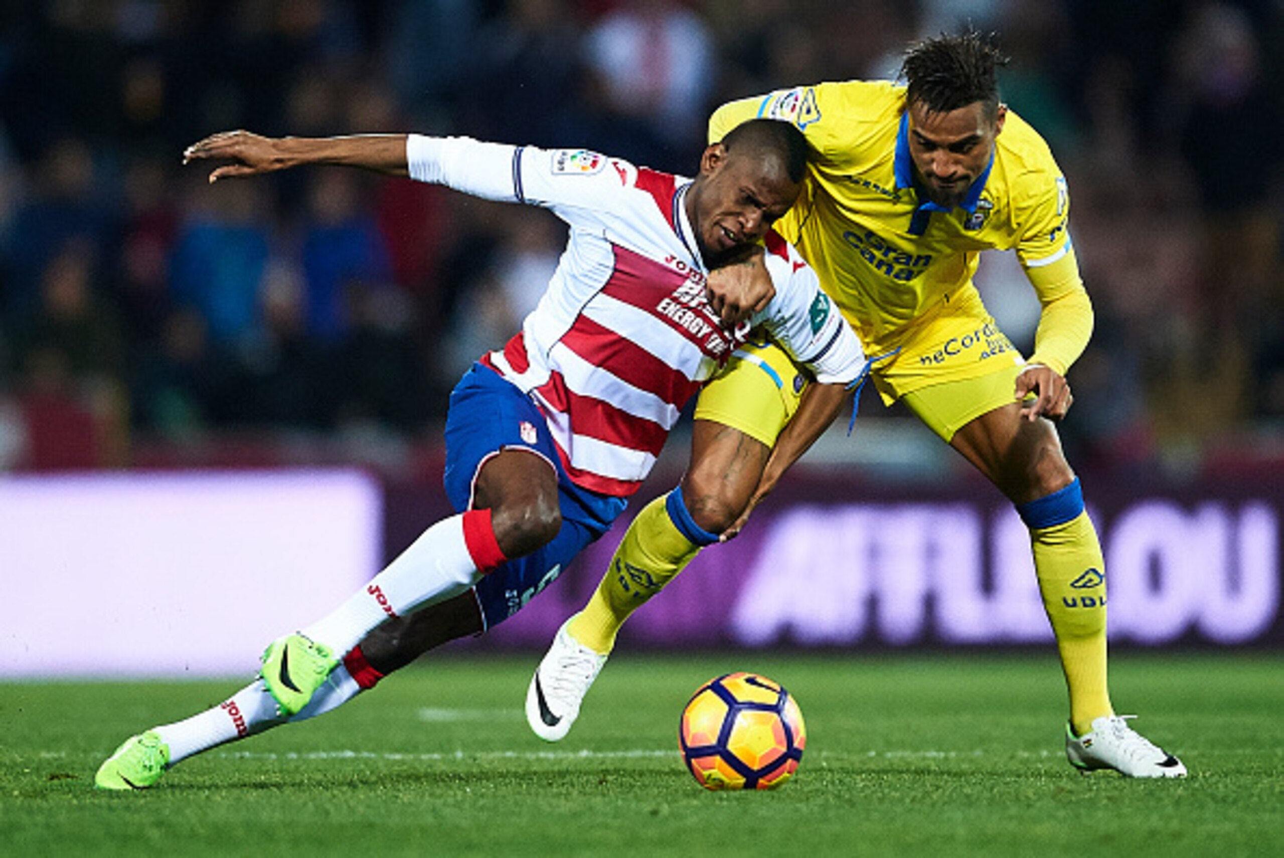 GRANADA, SPAIN - FEBRUARY 06:  Uche Henry Agbo of Granada CF (L) competes for the ball with Kevin Prince Boateng of Union Deportiva Las Palmas (R) during the La Liga match between Granada CF vs UD Las Palmas at Estadio Nuevo Los Carmenes on February 06, 2