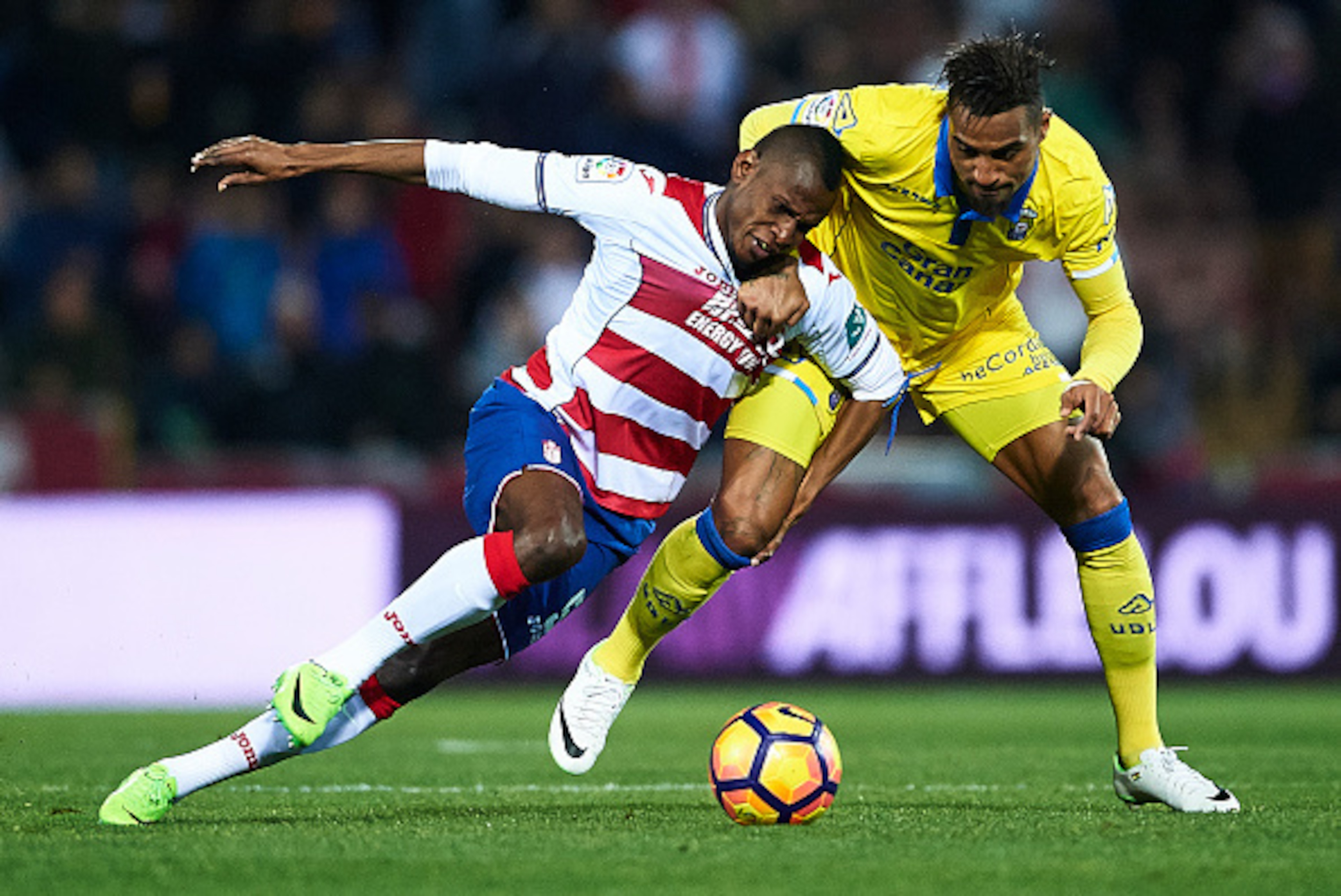 GRANADA, SPAIN - FEBRUARY 06:  Uche Henry Agbo of Granada CF (L) competes for the ball with Kevin Prince Boateng of Union Deportiva Las Palmas (R) during the La Liga match between Granada CF vs UD Las Palmas at Estadio Nuevo Los Carmenes on February 06, 2
