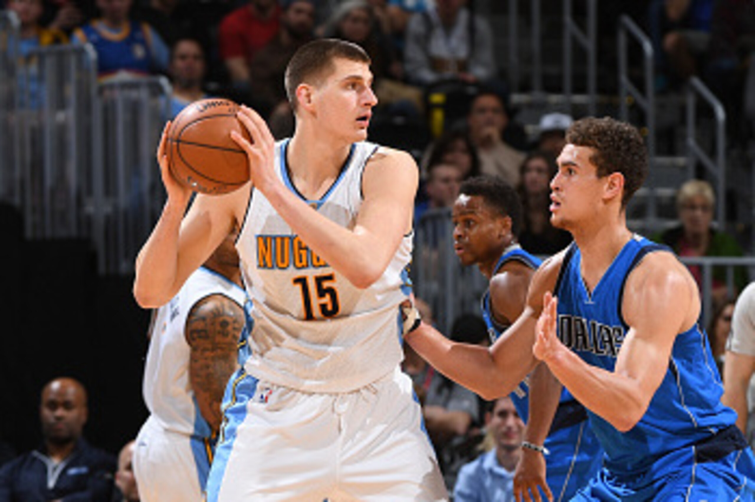 DENVER, CO - FEBRUARY 6:  Nikola Jokic #15 of the Denver Nuggets handles the ball against Dwight Powell #7 of the Dallas Mavericks during the game on February 6, 2017 at the Pepsi Center in Denver, Colorado. NOTE TO USER: User expressly acknowledges and a