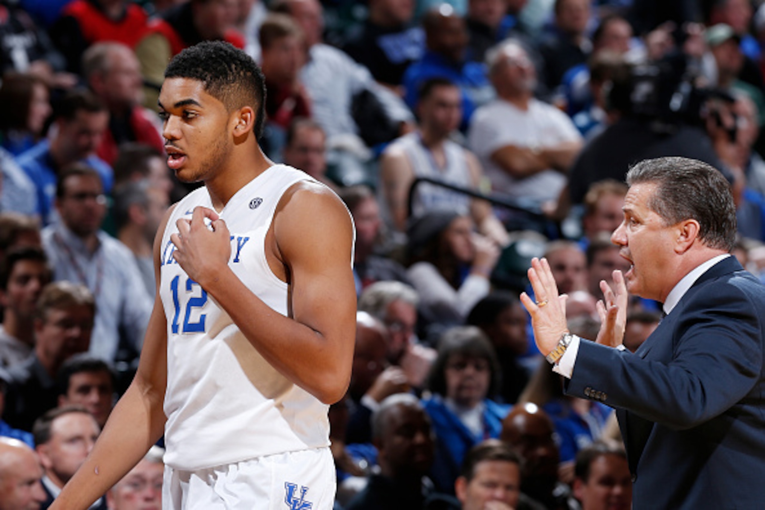 INDIANAPOLIS, IN - NOVEMBER 18: Karl-Anthony Towns #12 of the Kentucky Wildcats listens to head coach John Calipari during the State Farm Champions Classic against the Kansas Jayhawks at Bankers Life Fieldhouse on November 18, 2014 in Indianapolis, Indian