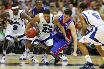 SAN ANTONIO - APRIL 07:  Derrick Rose #23 of the Memphis Tigers fends off Sasha Kaun #24 of the Kansas Jayhawks for posession of the ball in the first half during the 2008 NCAA Men's National Championship game at the Alamodome on April 7, 2008 in San Anto