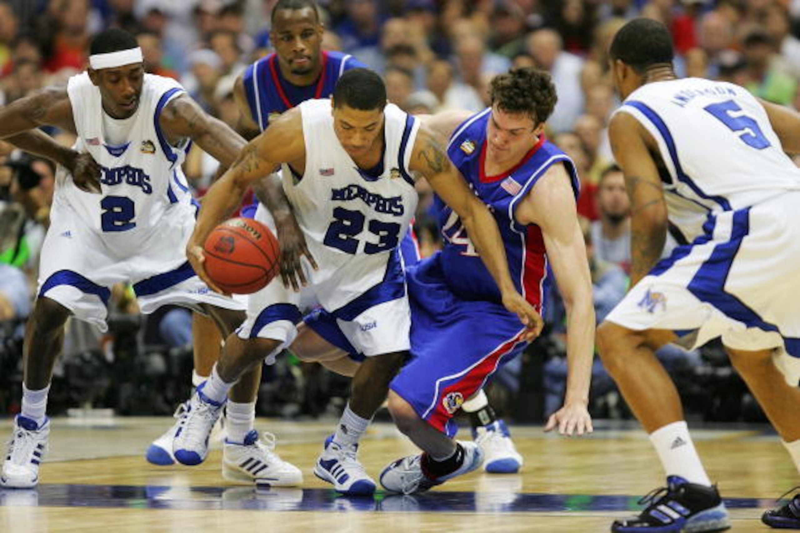 SAN ANTONIO - APRIL 07:  Derrick Rose #23 of the Memphis Tigers fends off Sasha Kaun #24 of the Kansas Jayhawks for posession of the ball in the first half during the 2008 NCAA Men's National Championship game at the Alamodome on April 7, 2008 in San Anto