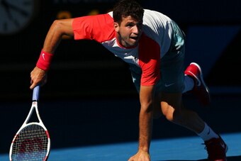MELBOURNE, AUSTRALIA - JANUARY 22:  Grigor Dimitrov of Bulgaria gets back on his feet after a fall in his quarterfinal match against Rafael Nadal of Spain during day 10 of the 2014 Australian Open at Melbourne Park on January 22, 2014 in Melbourne, Austra