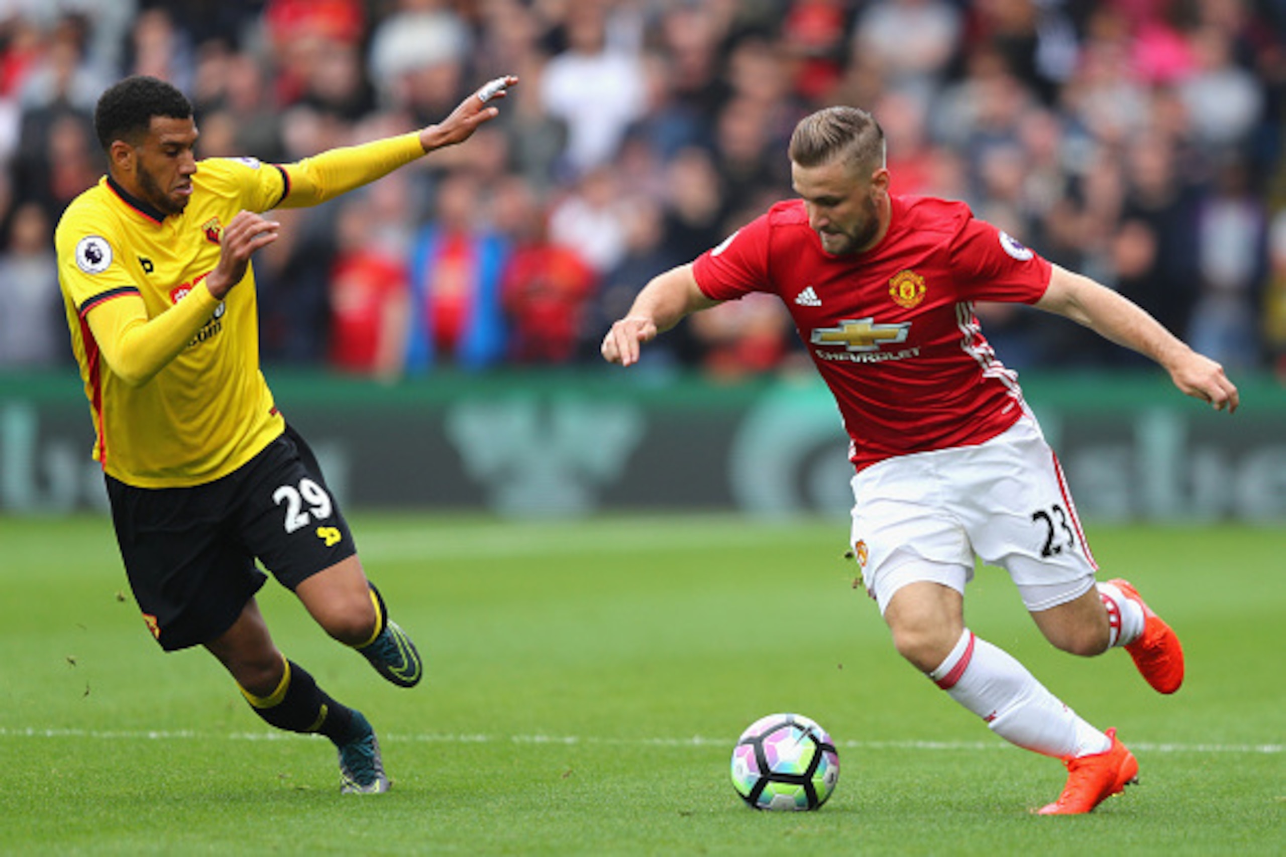 WATFORD, ENGLAND - SEPTEMBER 18: Luke Shaw of Manchester United (R) takes the ball past Etienne Capoue of Watford (L)  during the Premier League match between Watford and Manchester United at Vicarage Road on September 18, 2016 in Watford, England.  (Phot