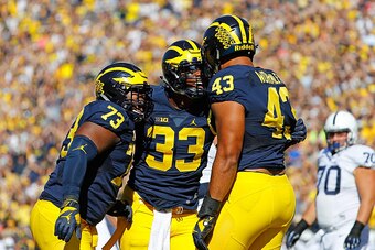ANN ARBOR, MI - SEPTEMBER 24: Chris Wormley #43 of the Michigan Wolverines celebrates after sacking the quarterback during the first quarter of the game against the Penn State Nittany Lions with his teammates Maurice Hurst #73 and Taco Charlton #33 at Mic