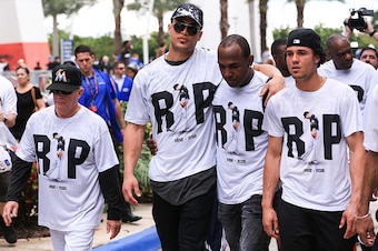 MIAMI, FL - SEPTEMBER 28: (left to right) Perry Hill, Giancarlo Stanton, Marcell Ozuna and Yefri Perez return to the stadium after surrounding the hearse carrying Miami Marlins pitcher Jose Fernandez to pay their respects on September 28, 2016 in Miami, F
