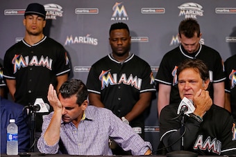 MIAMI, FL - SEPTEMBER 25:   Miami Marlins team president David Samson, front left, manager Don Mattingly (R) and players behind from left, Giancarlo Stanton, Fernando Rodney and Chris Johnson react during a press conference after pitcher Jose Fernanedez d