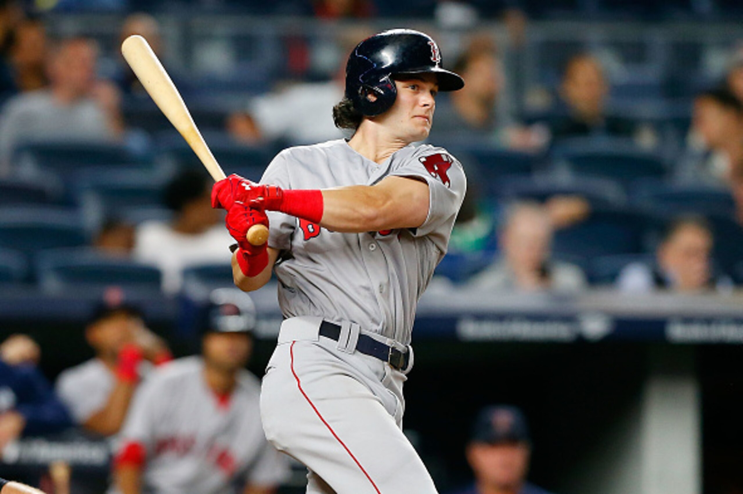 NEW YORK, NY - SEPTEMBER 27:  Andrew Benintendi #40 of the Boston Red Sox follows through on a ninth inning double against the New York Yankees at Yankee Stadium on September 27, 2016 in the Bronx borough of New York City. The Yankees defeated the Red Sox