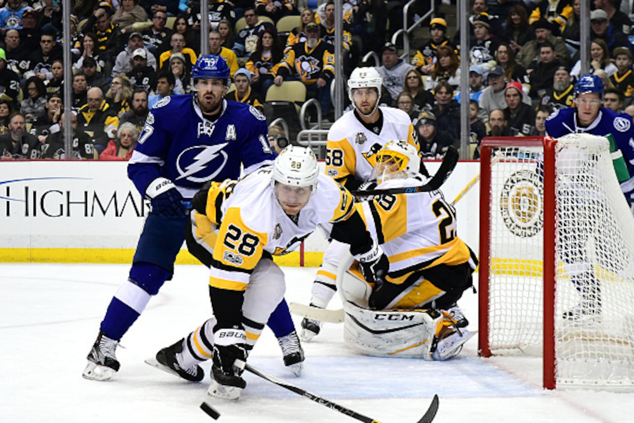 PITTSBURGH, PA - JANUARY 08: Ian Cole #28 of the Pittsburgh Penguins reaches for the puck against the Tampa Bay Lightning at PPG PAINTS Arena on January 8, 2017 in Pittsburgh, Pennsylvania. (Photo by Matt Kincaid/Getty Images)