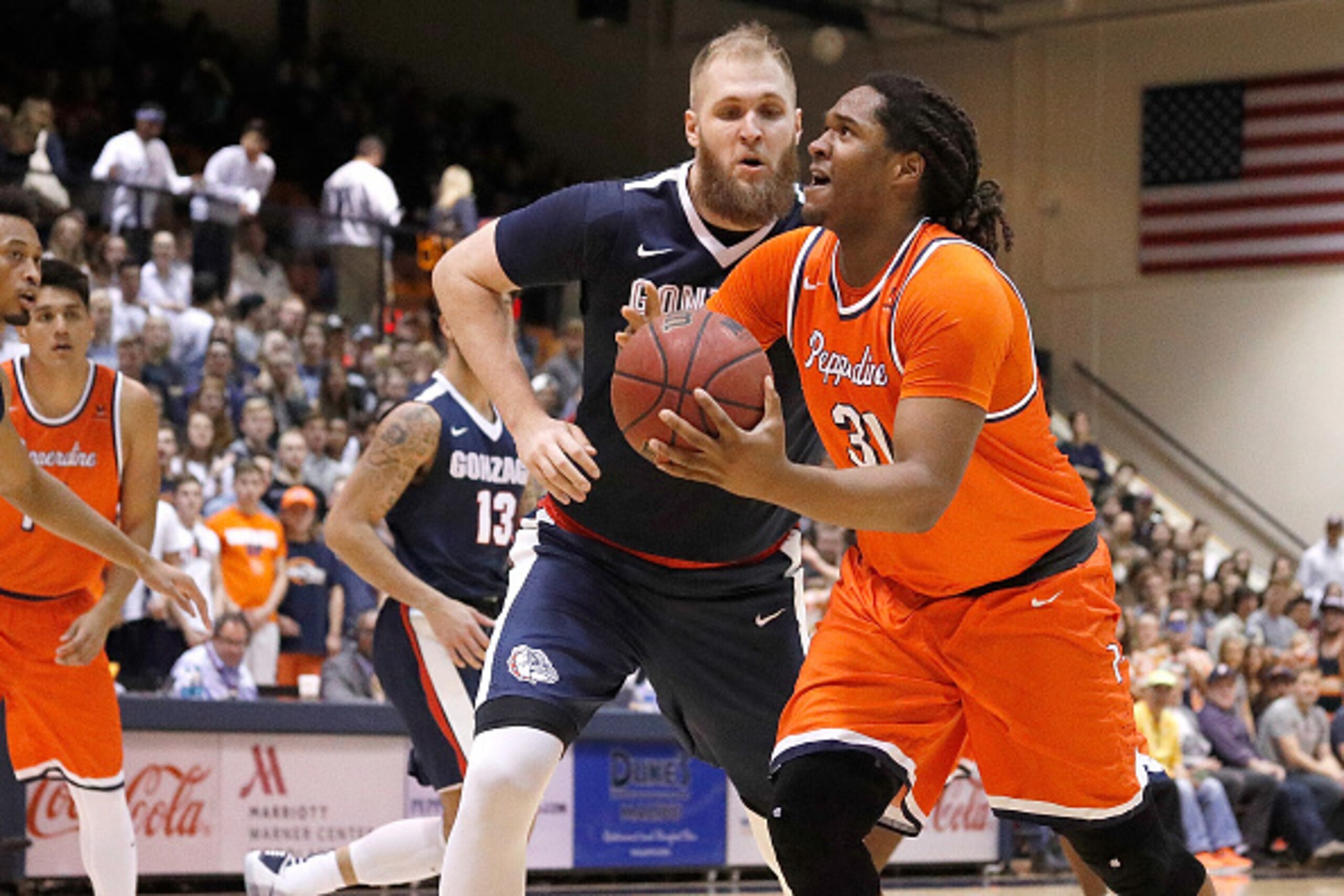 MALIBU, CA - JANUARY 28: Nolan Taylor #31 of the Pepperdine Waves looks to shoot the ball while being guarded by Przemek Karnowski #24 of the Gonzaga Bulldogs during the game against the Gonzaga Bulldogs at Firestone Fieldhouse on January 28, 2017 in Mali