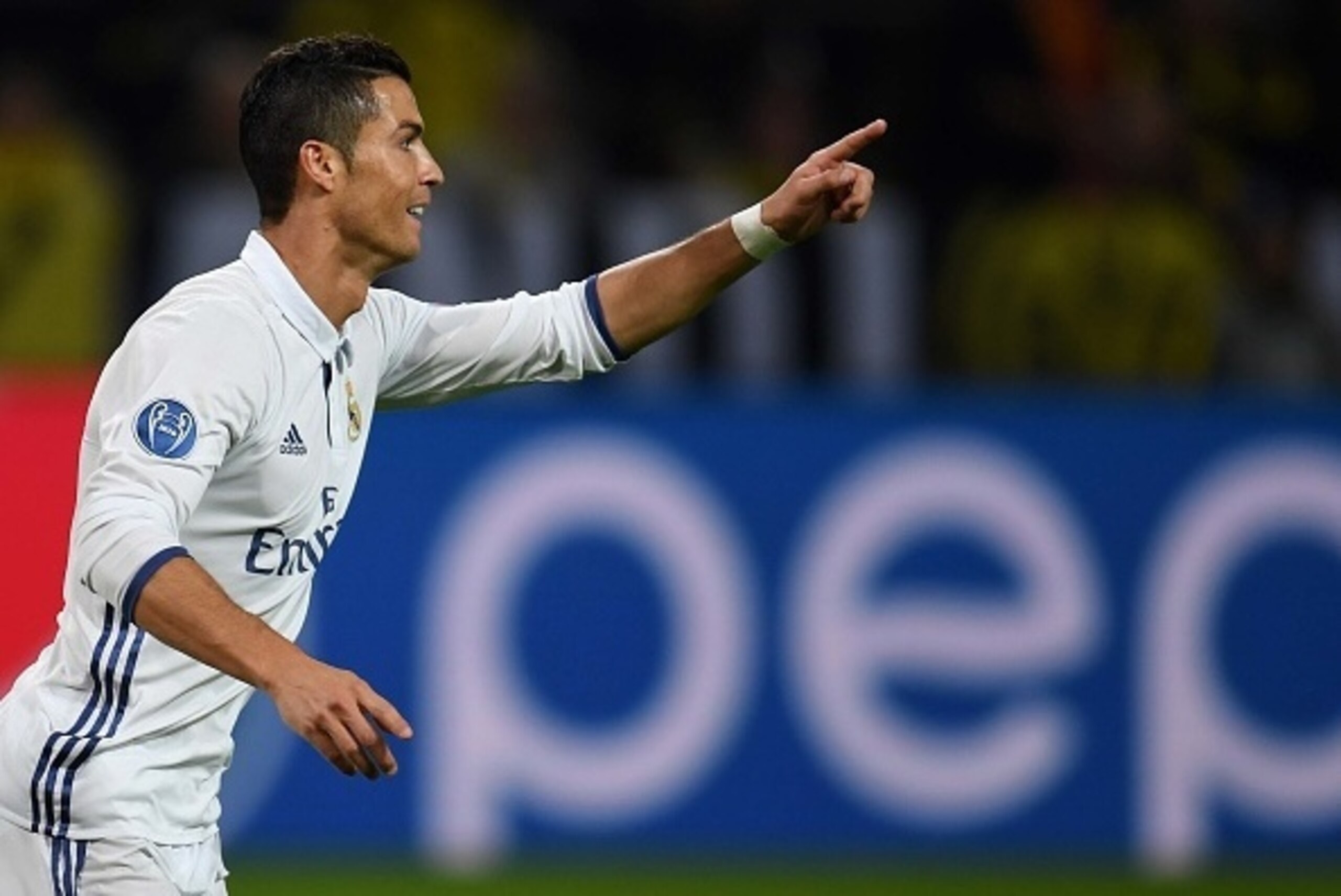 Real Madrid's Portuguese forward Cristiano Ronaldo celebrates after his goal during the UEFA Champions League first leg football match between Borussia Dortmund and Real Madrid at BVB stadium in Dortmund, on September 27, 2016. / AFP / PATRIK STOLLARZ    
