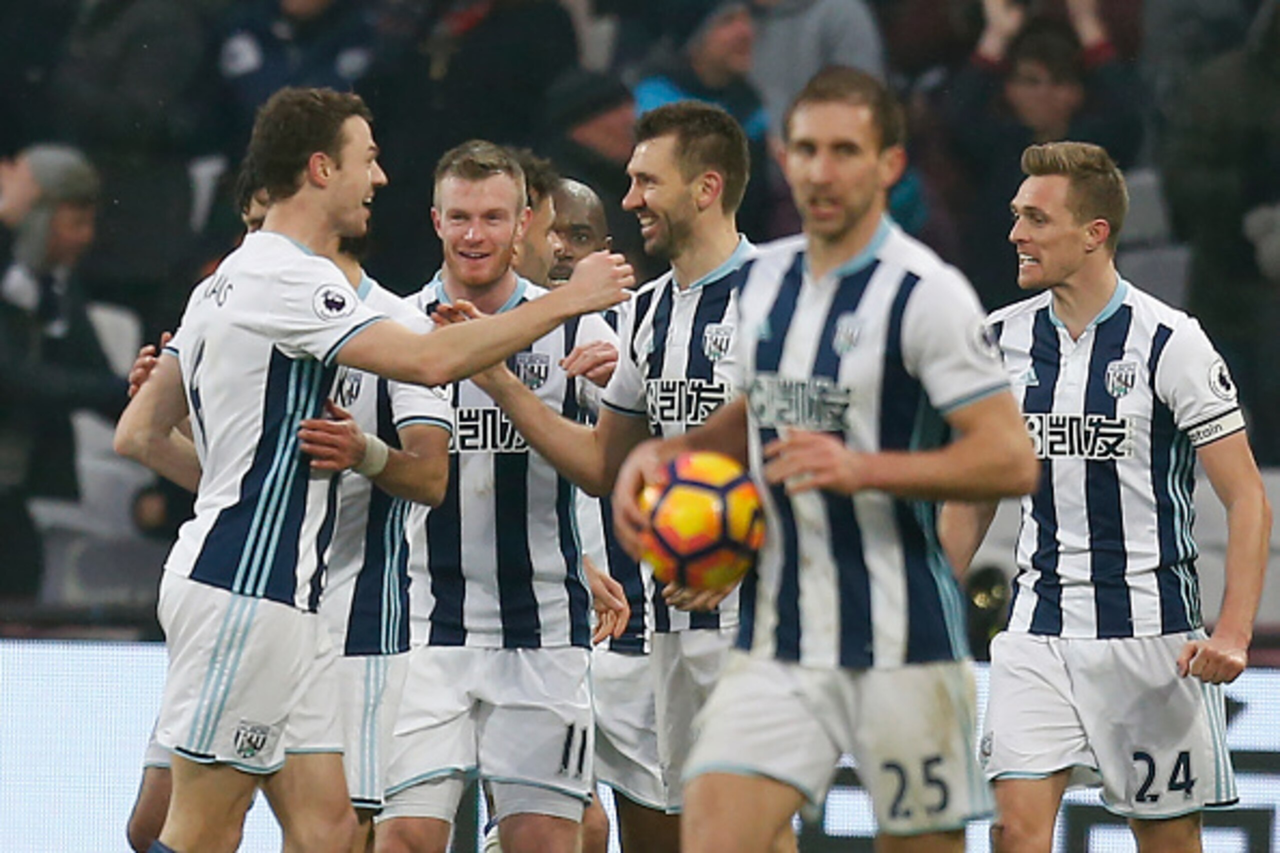 West Bromwich Albion's Northern Irish defender Jonny Evans (L) and West Bromwich Albion's Northern Irish defender Gareth McAuley (C) celebrate their late equalizer during the English Premier League football match between West Ham United and West Bromwich 