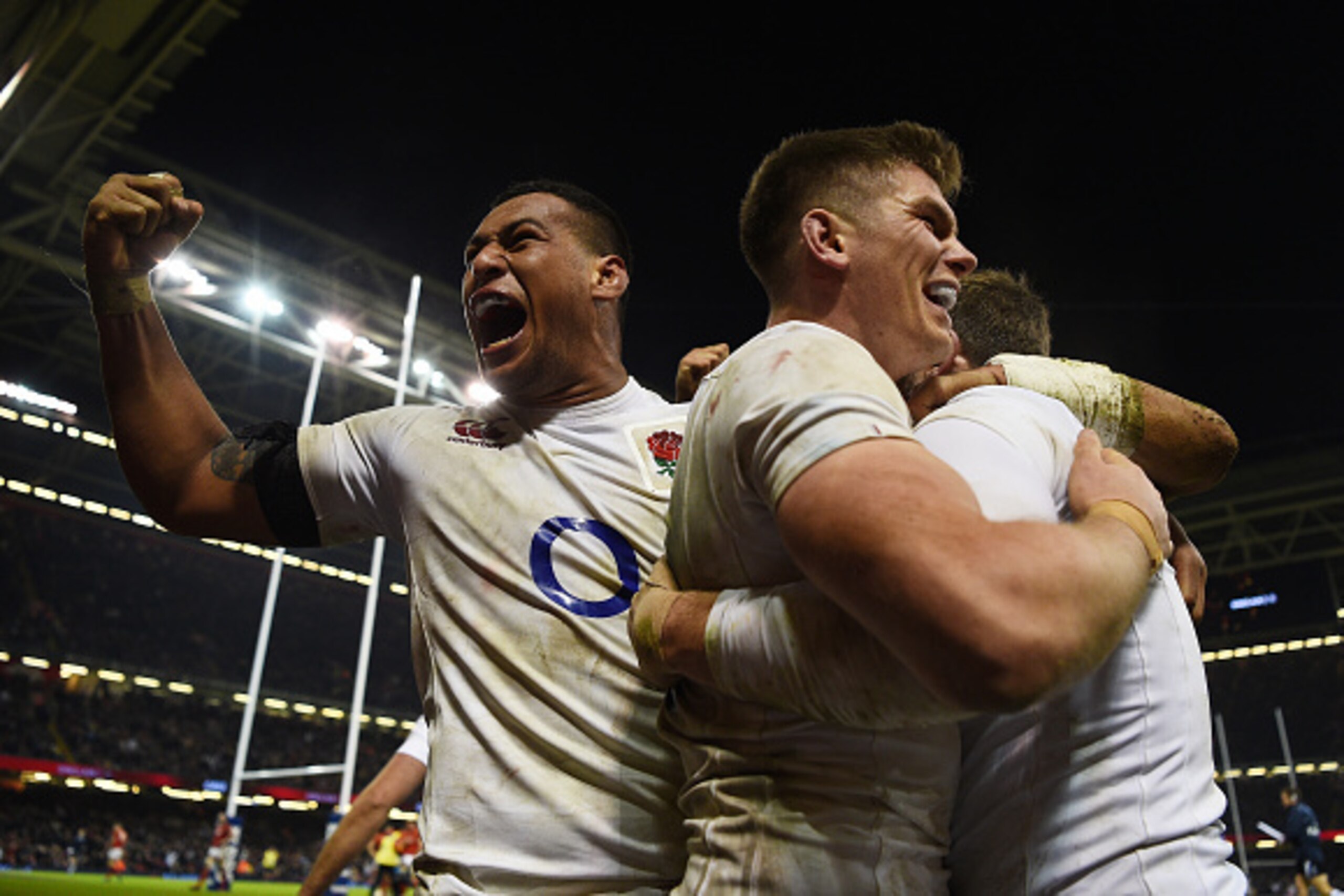 CARDIFF, WALES - FEBRUARY 11:  Elliot Daly of England is congratulated by teammates Nathan Hughes (L) and Owen Farrell (C) of England after scoring the match winning try during the RBS Six Nations match between Wales and England at the Principality Stadiu