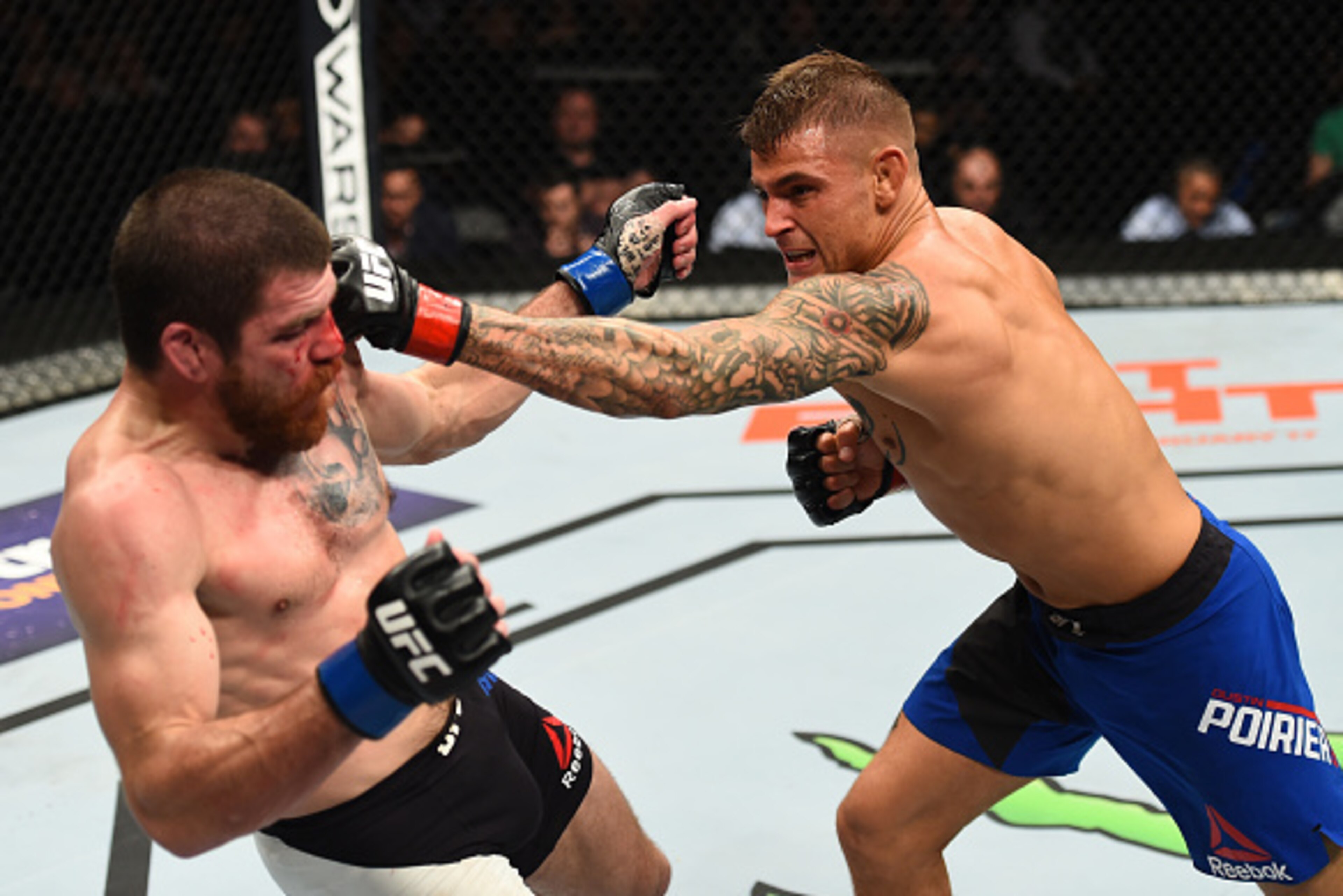 BROOKLYN, NEW YORK - FEBRUARY 11:  (R-L) Dustin Poirier punches Jim Miller in their lightweight bout during the UFC 208 event inside Barclays Center on February 11, 2017 in Brooklyn, New York. (Photo by Jeff Bottari/Zuffa LLC/Zuffa LLC via Getty Images)